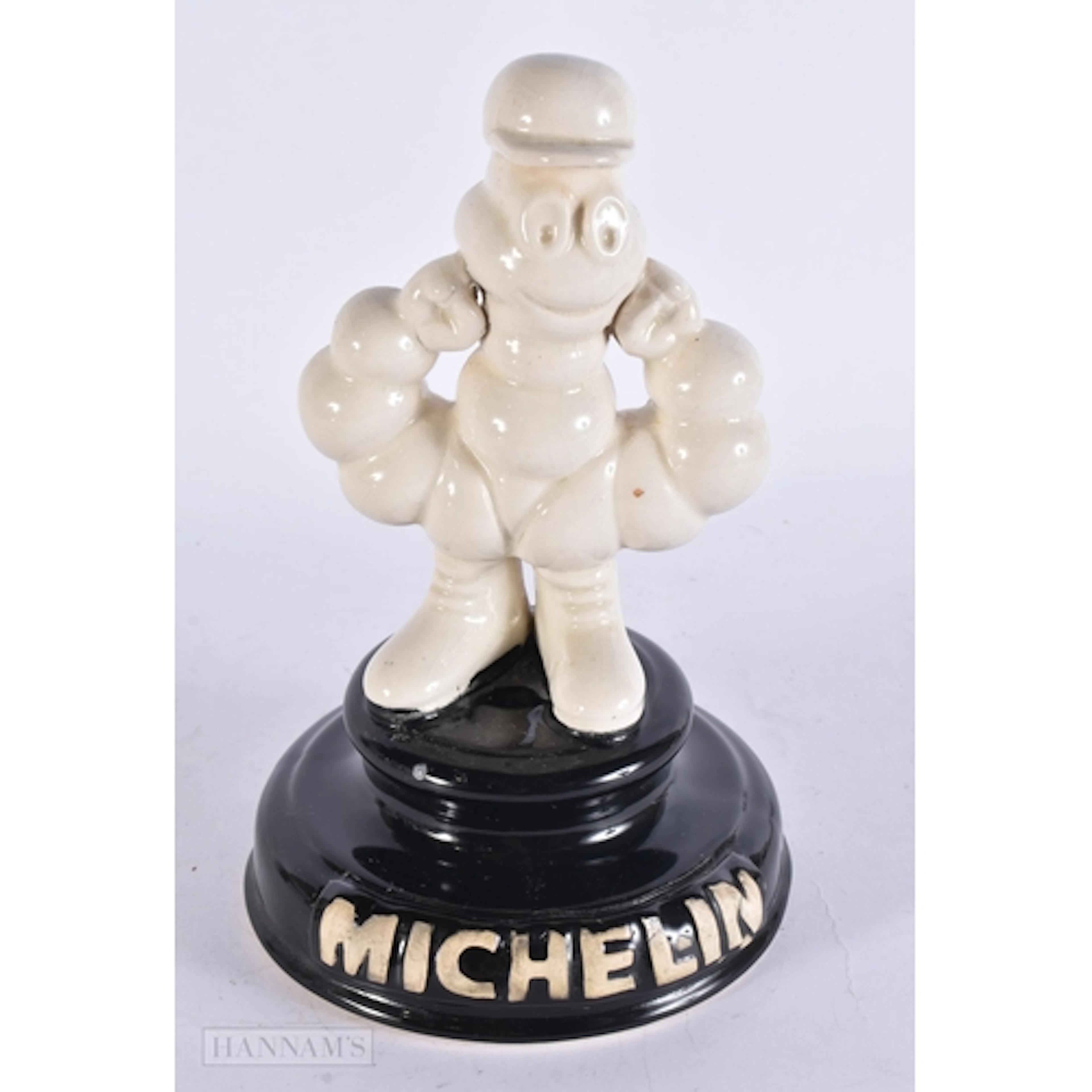 A CERAMIC MICHELIN MAN ADVERTISING FIGURE. 26 cm x 12 cm.