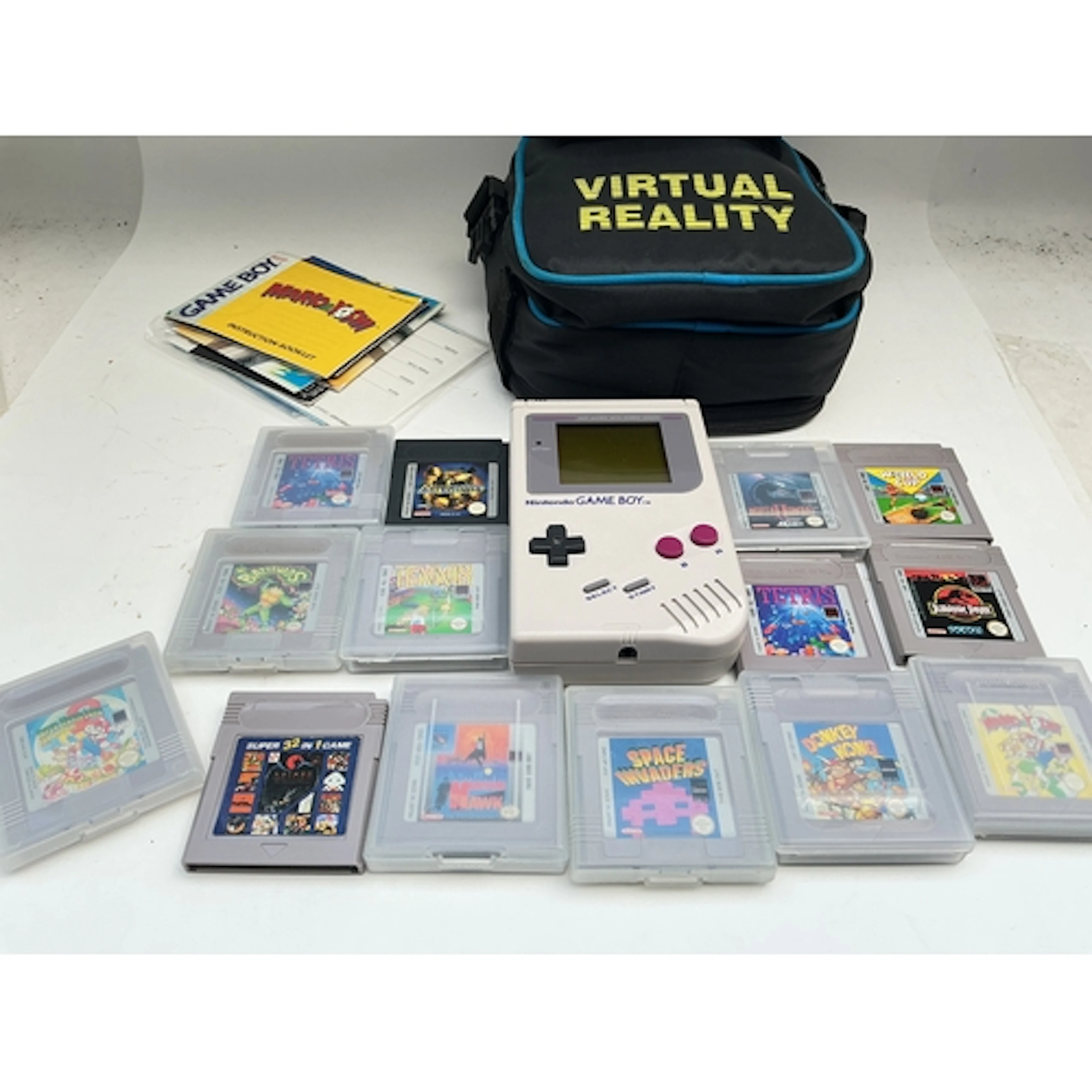 A Nintendo Game Boy And A Collection Of Games.