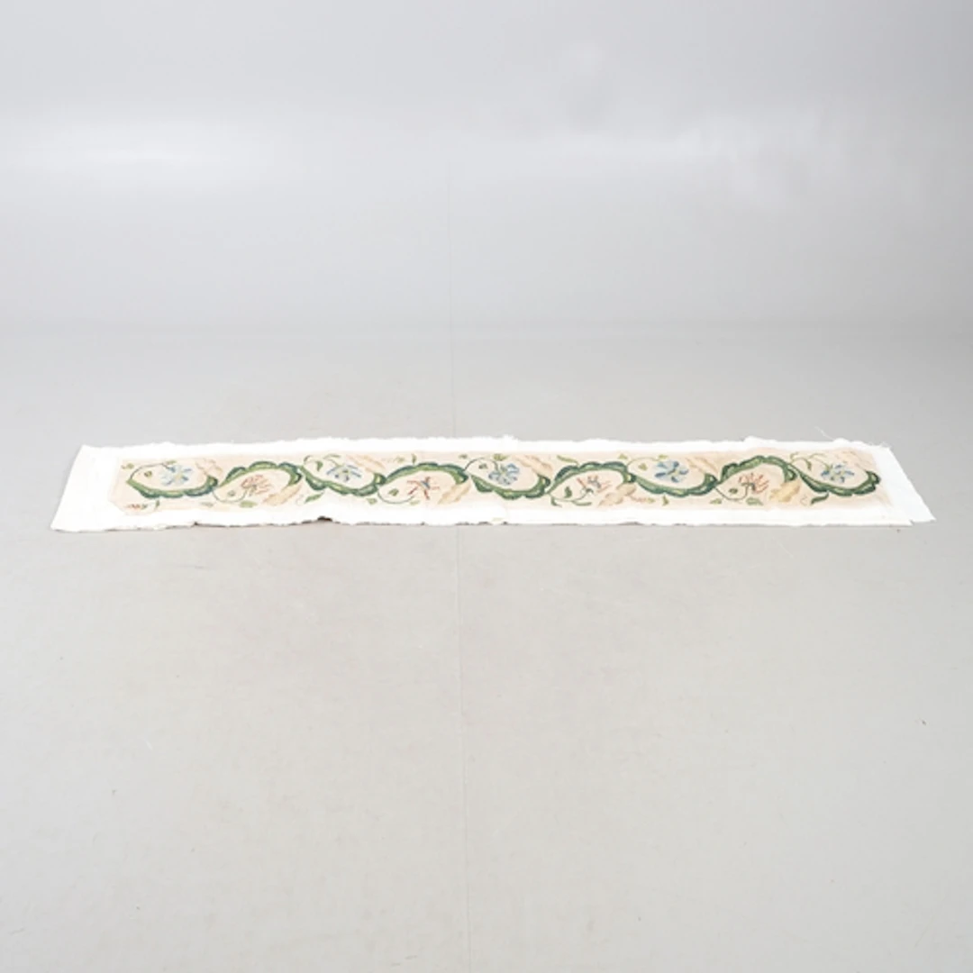 A LENGTH OF 18TH CENTURY EMBROIDERY. the design of flowers a...