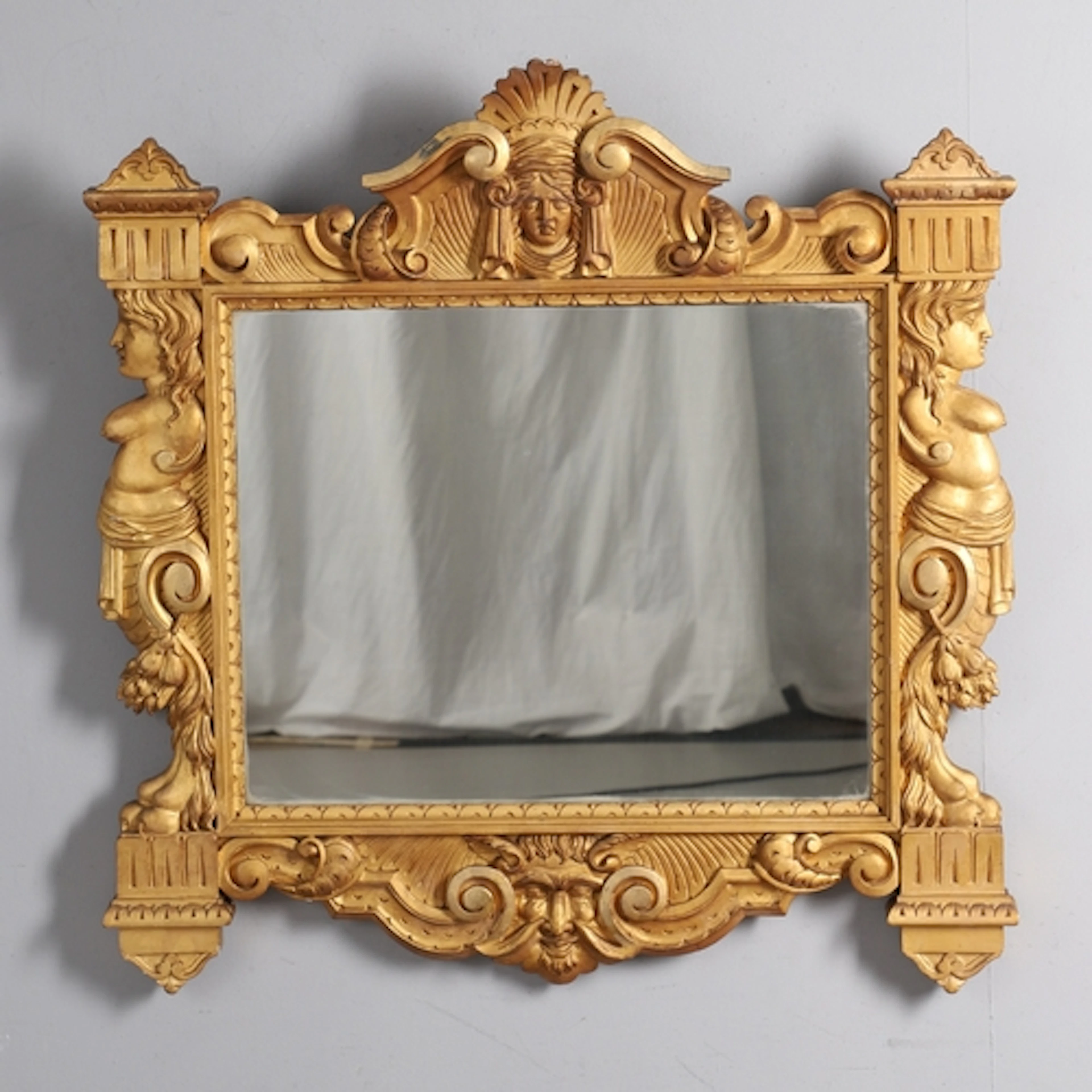 A 19TH CENTURY ITALIANATE GILTWOOD WALL MIRROR. the frame ca...