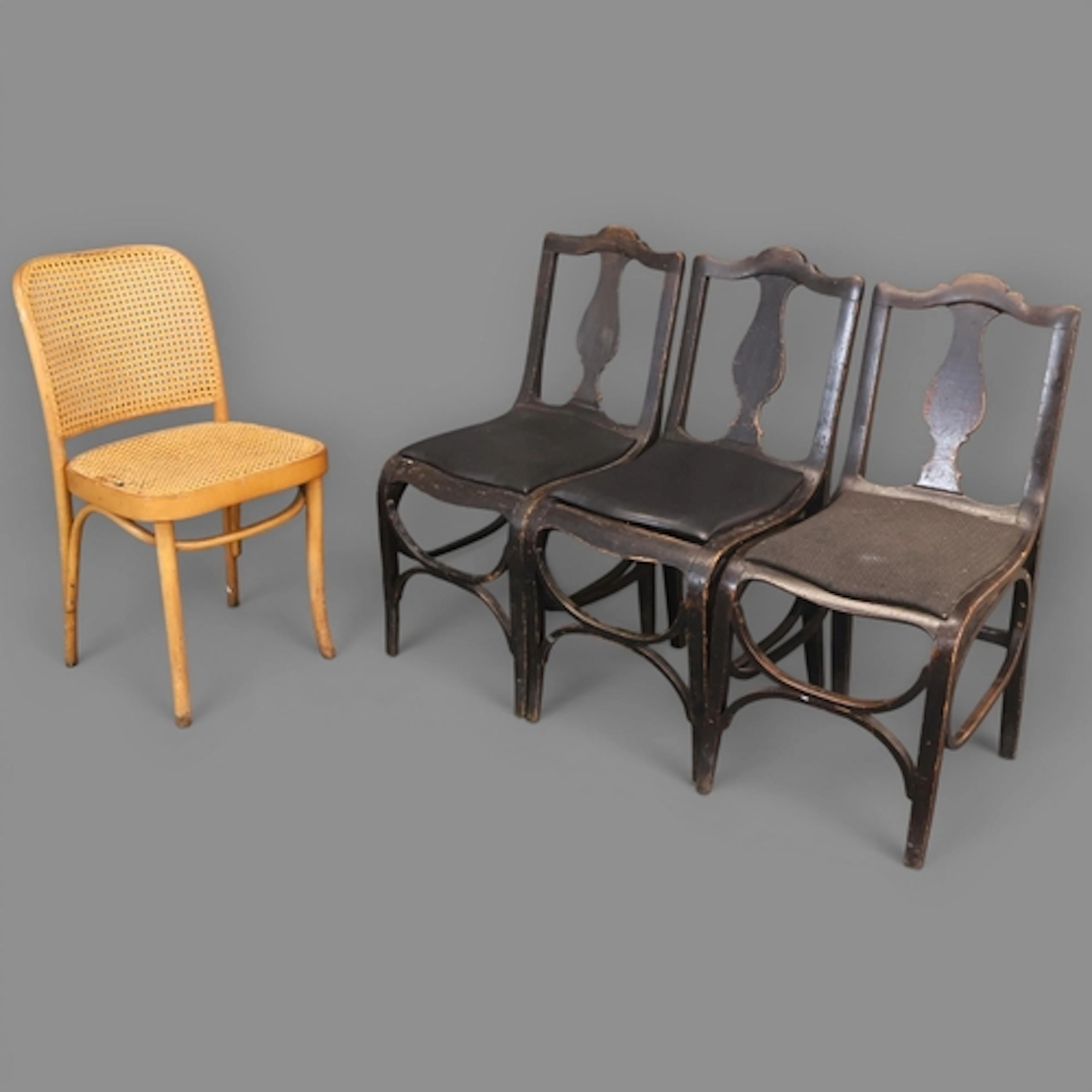 A mid-century bentwood chair with caned seat and back in the...