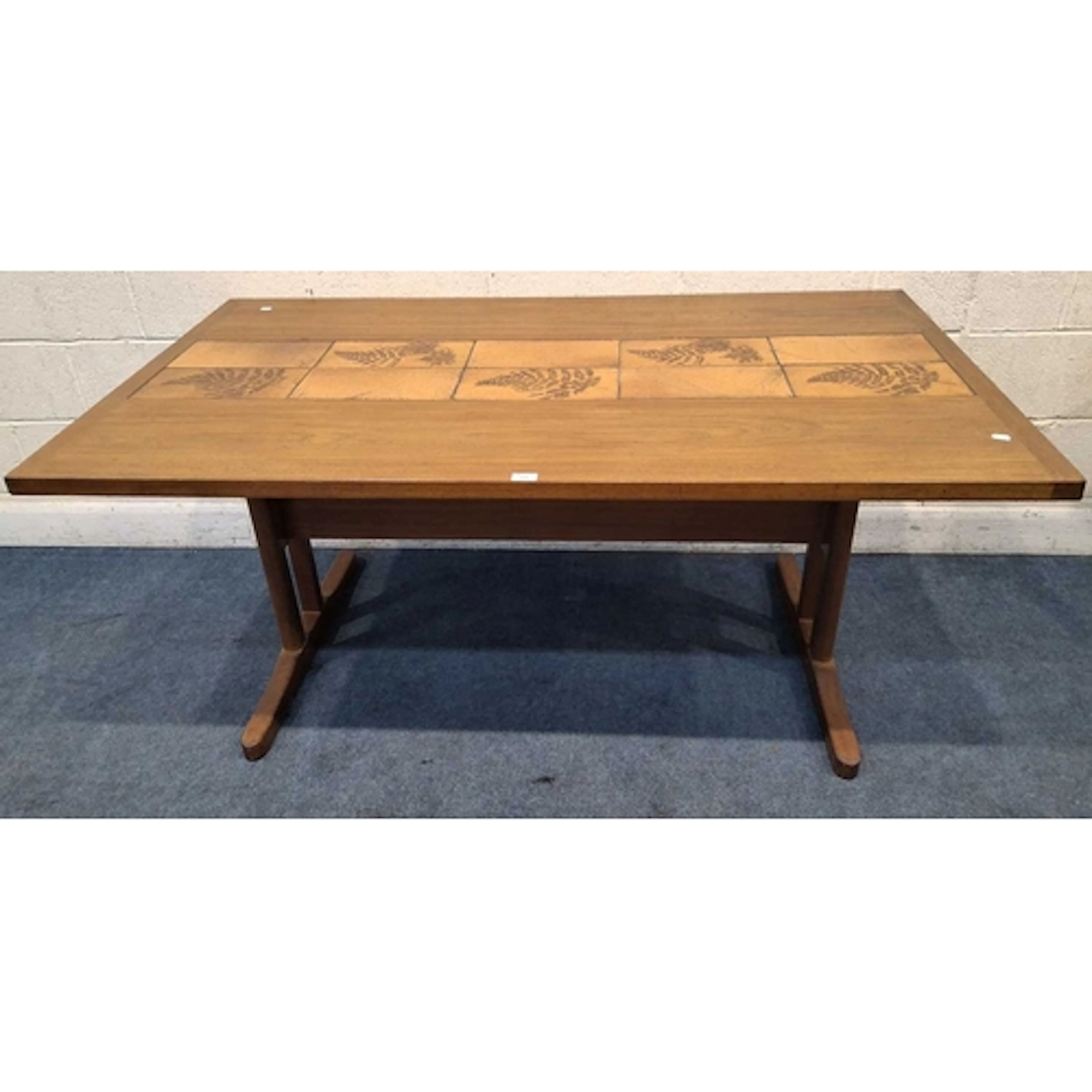A MID-CENTURY TEAK RECTANGULAR TABLE, with a tile strip down...