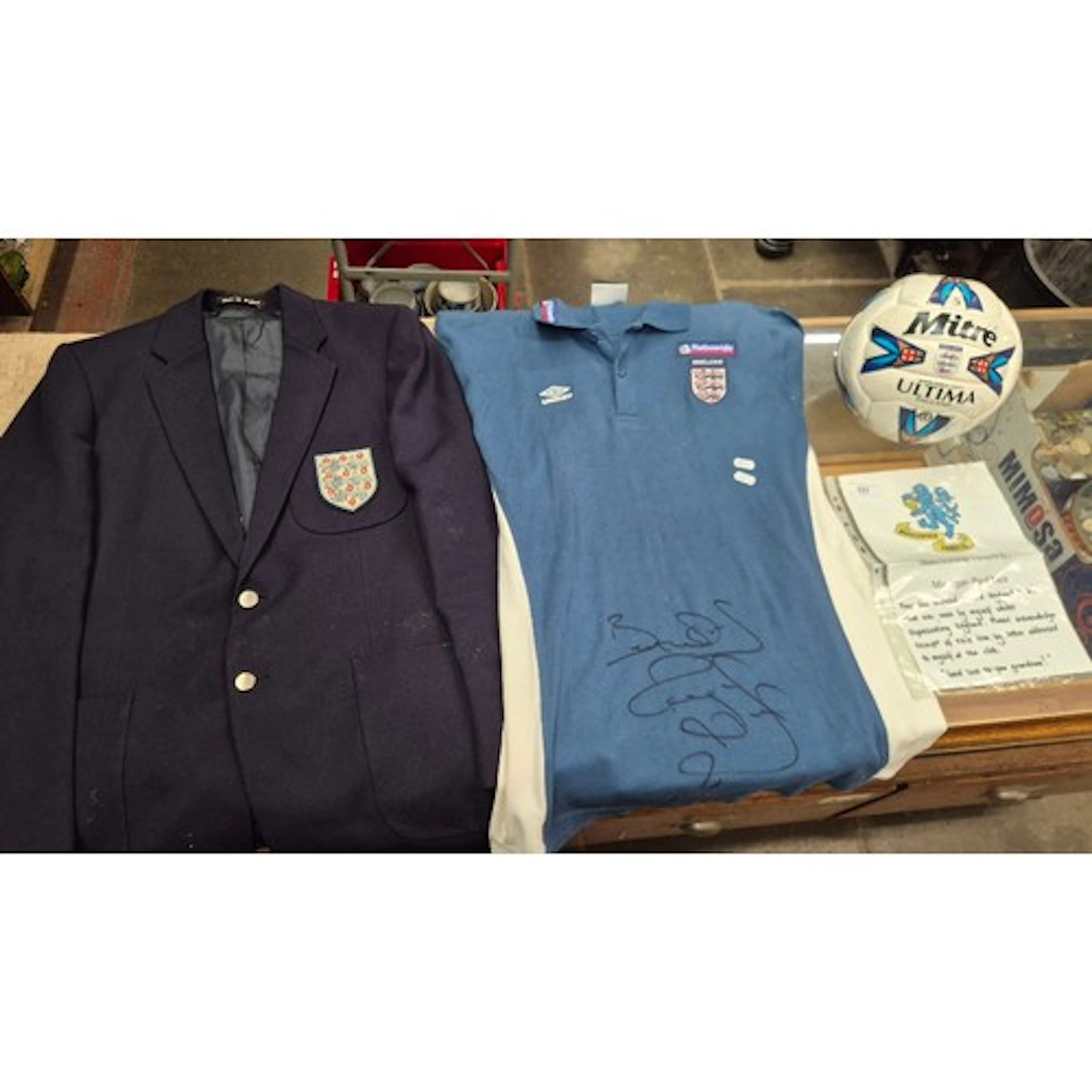 A group of three England football memorabilia items comprisi...