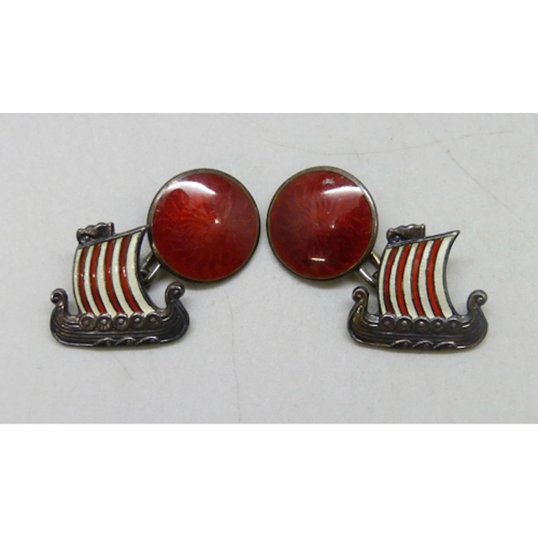 A pair of Scandinavian silver and enamel cufflinks in the fo...