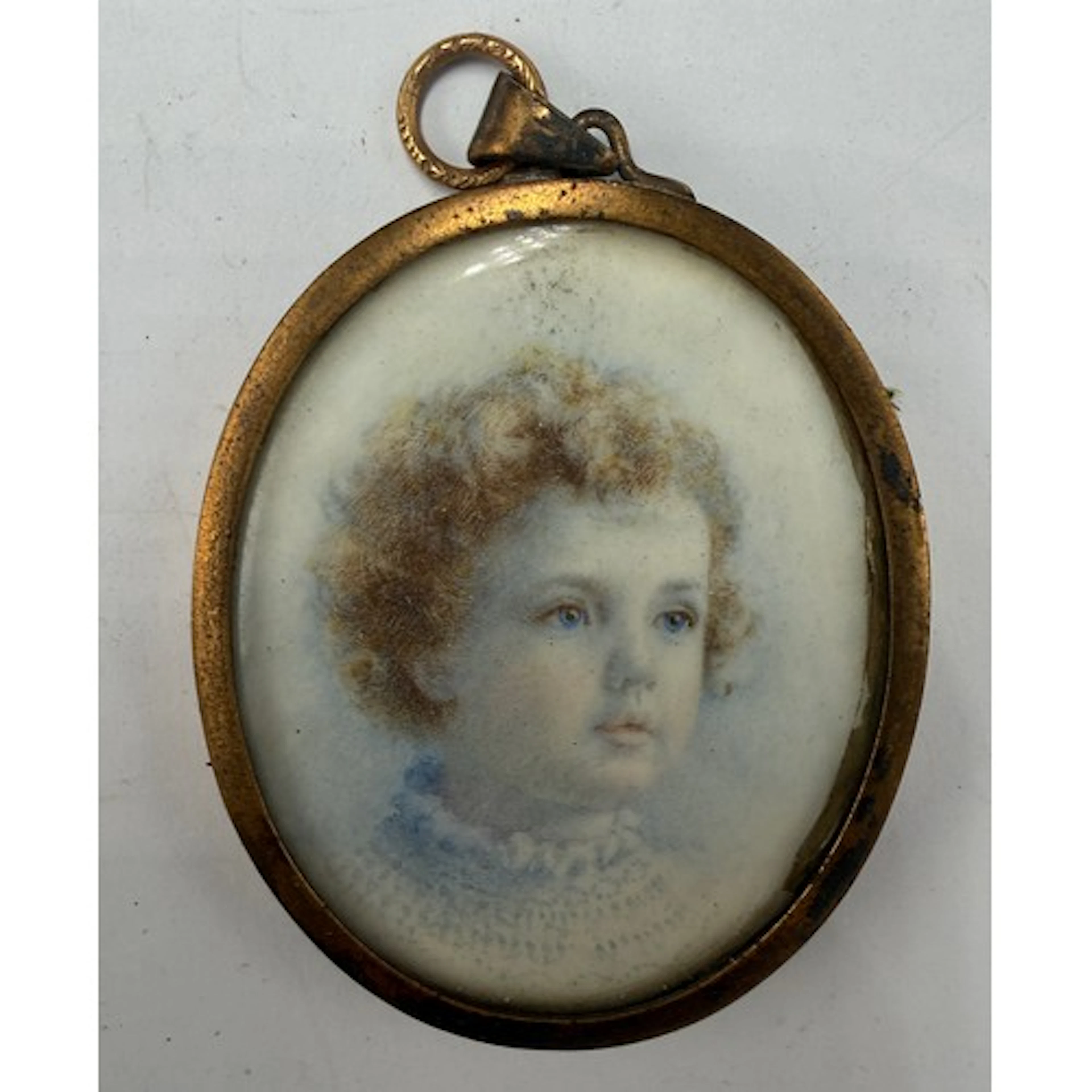 A miniature portrait on ivory in gilt metal oval frame. Head...