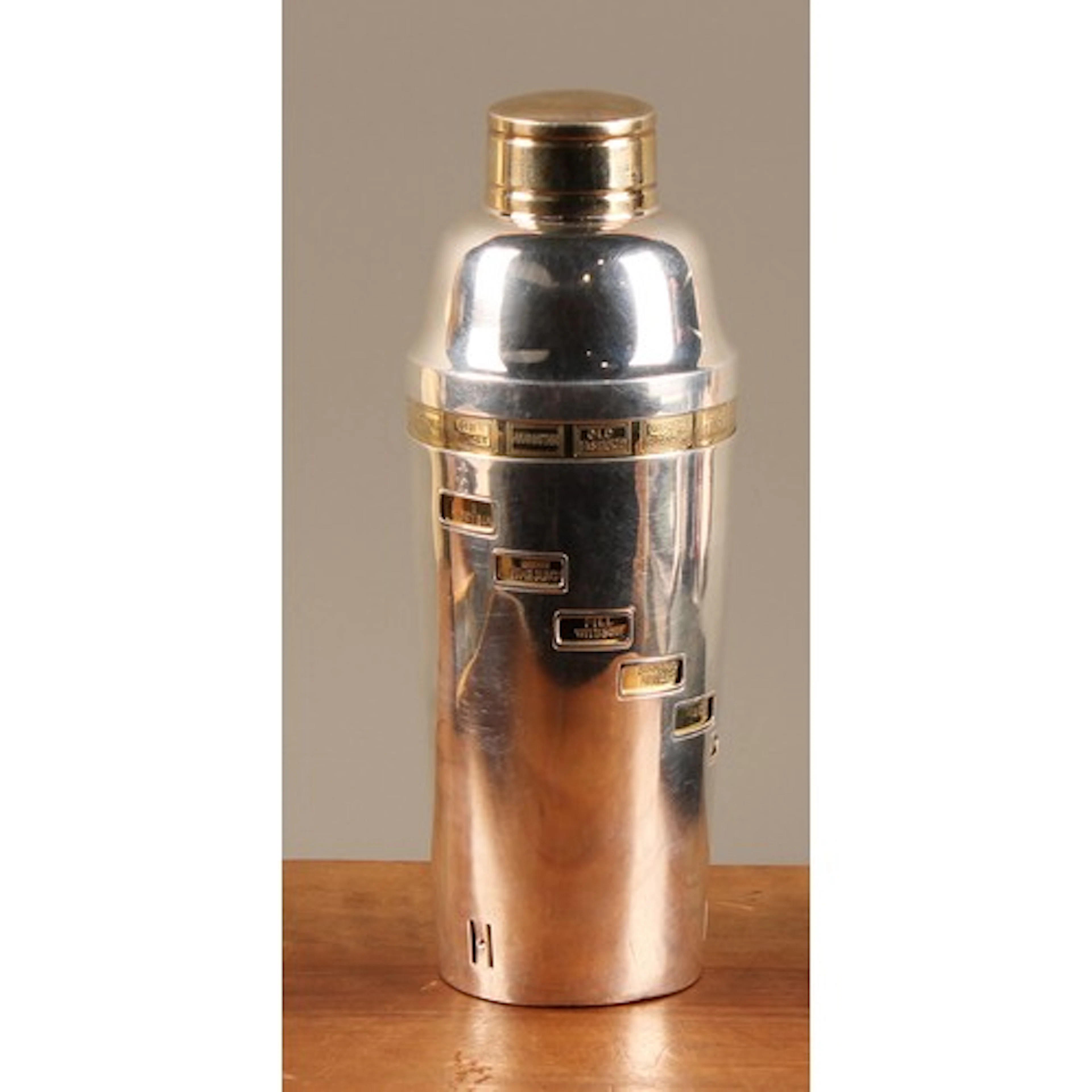 An Art Deco parcel-gilt silver plated recipe cocktail shaker...