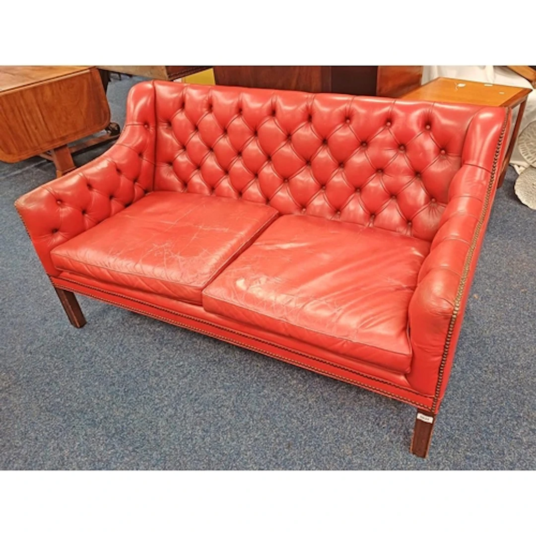 BUTTON RED LEATHER SETTEE WITH BRASS STUD WORK