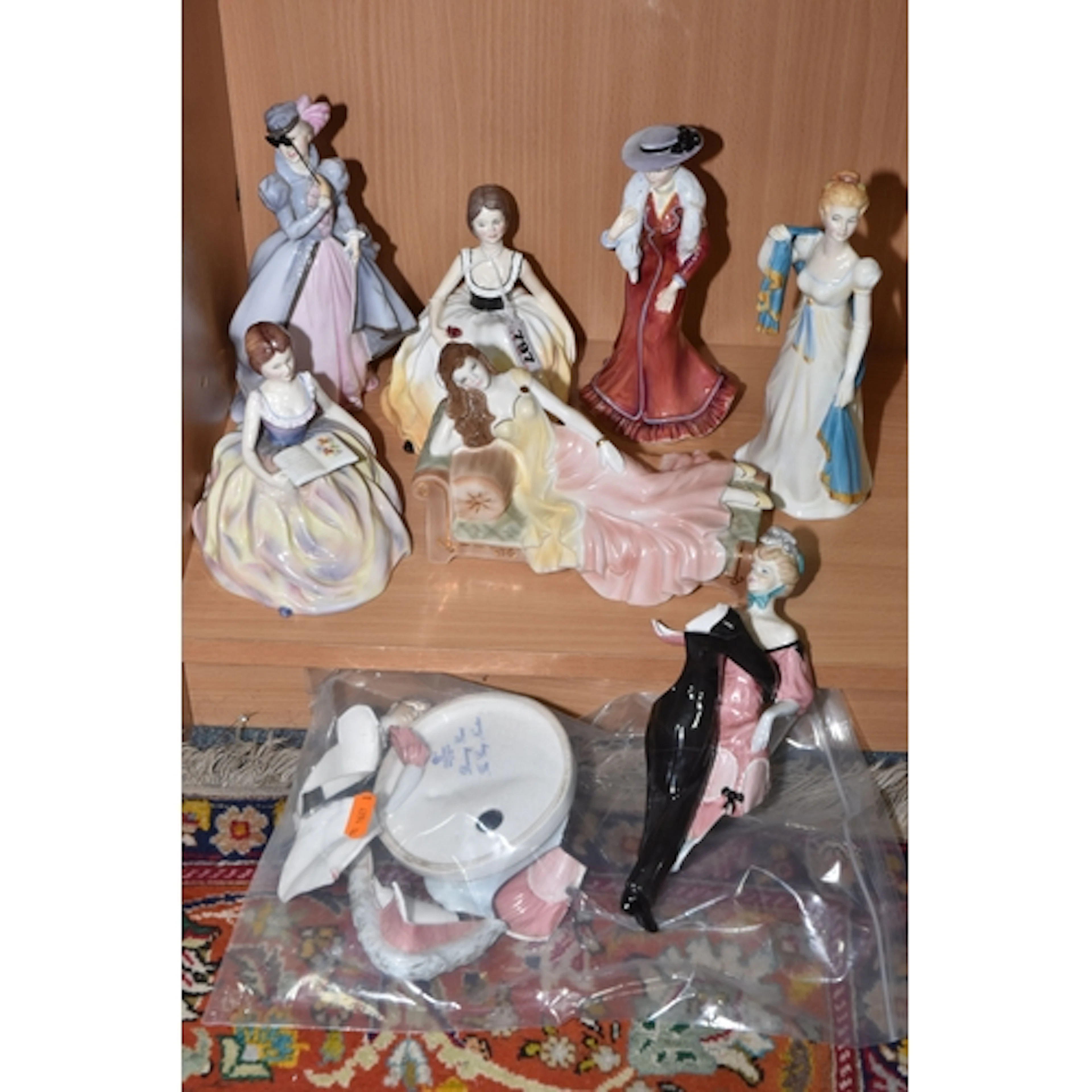 A GROUP OF SIX PORCELAIN LADIES comprising four figures from...