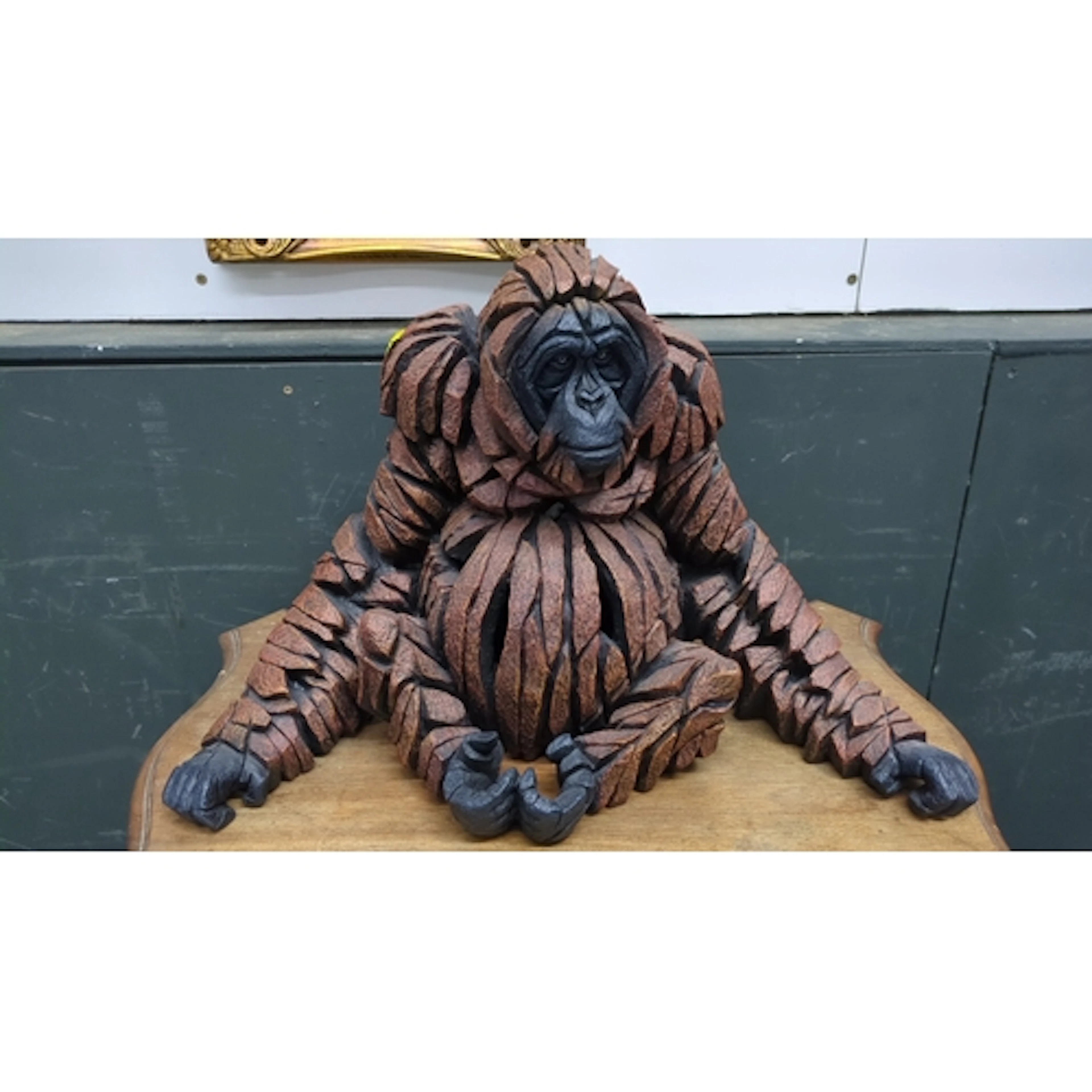 Contemporary resin sculpture of a seated orangutan; signed '...