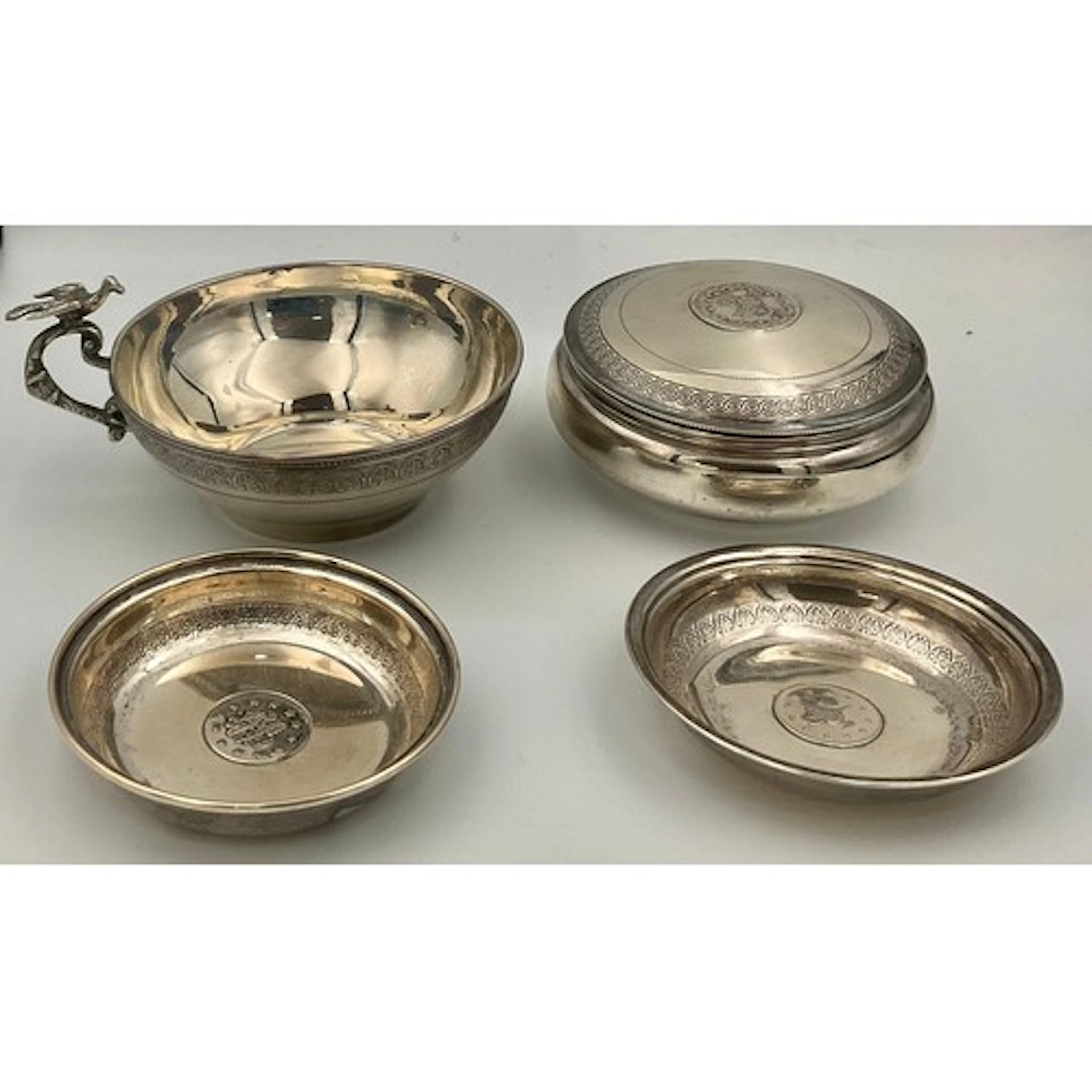 A Turkish silver coloured metal circular box and cover, the ...