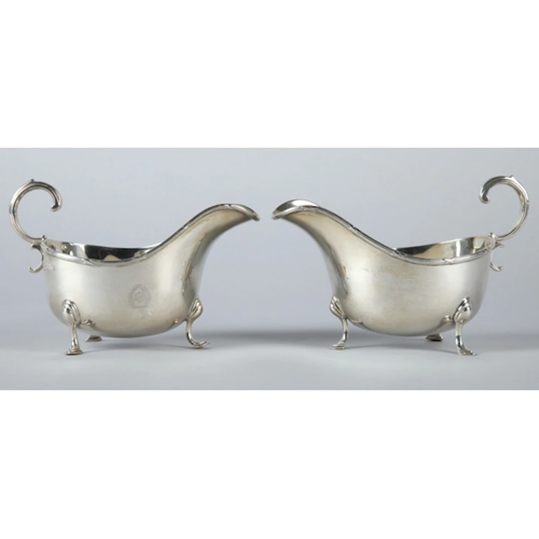 Pair of George V silver sauce boats raised on three cabriole...