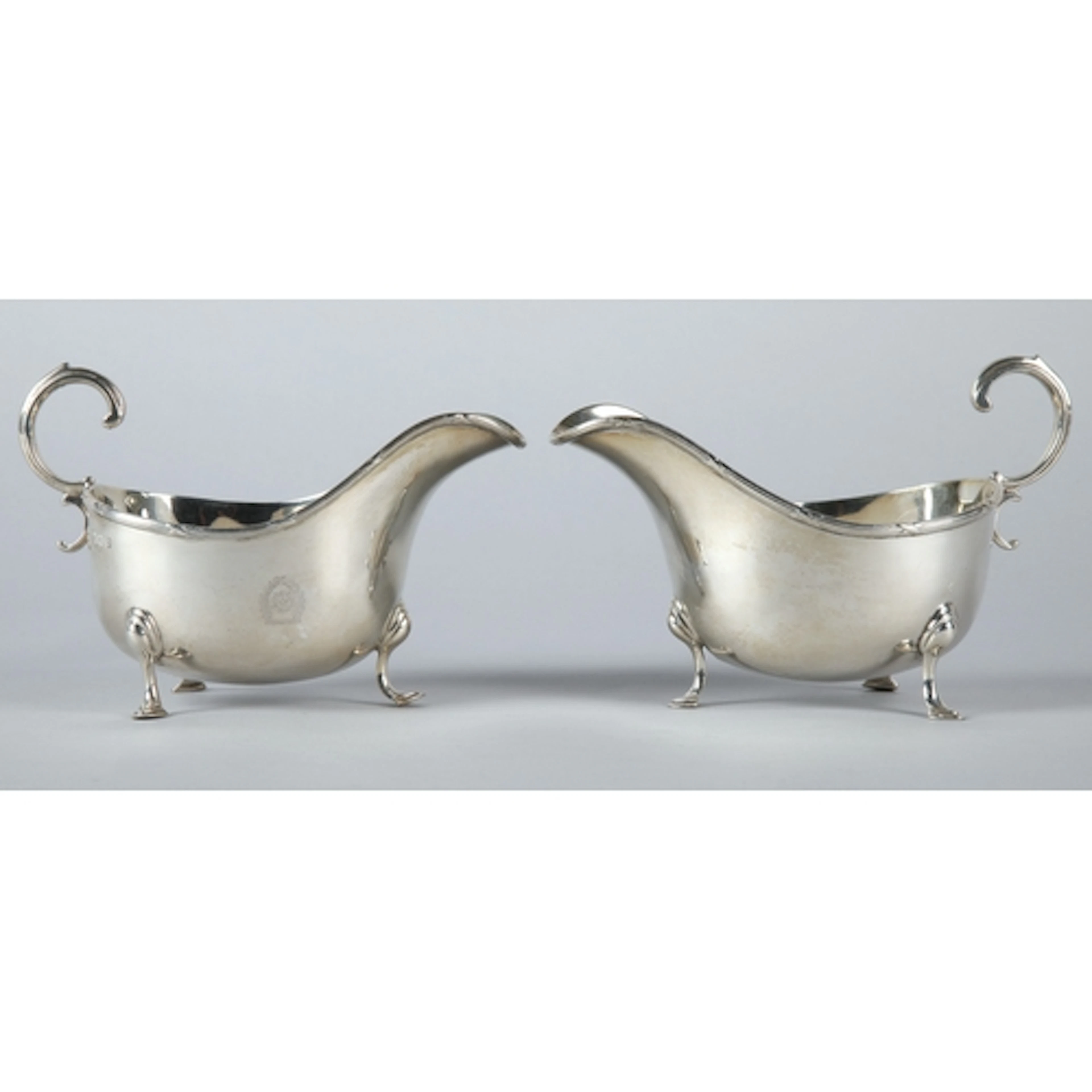 Pair of George V silver sauce boats raised on three cabriole...