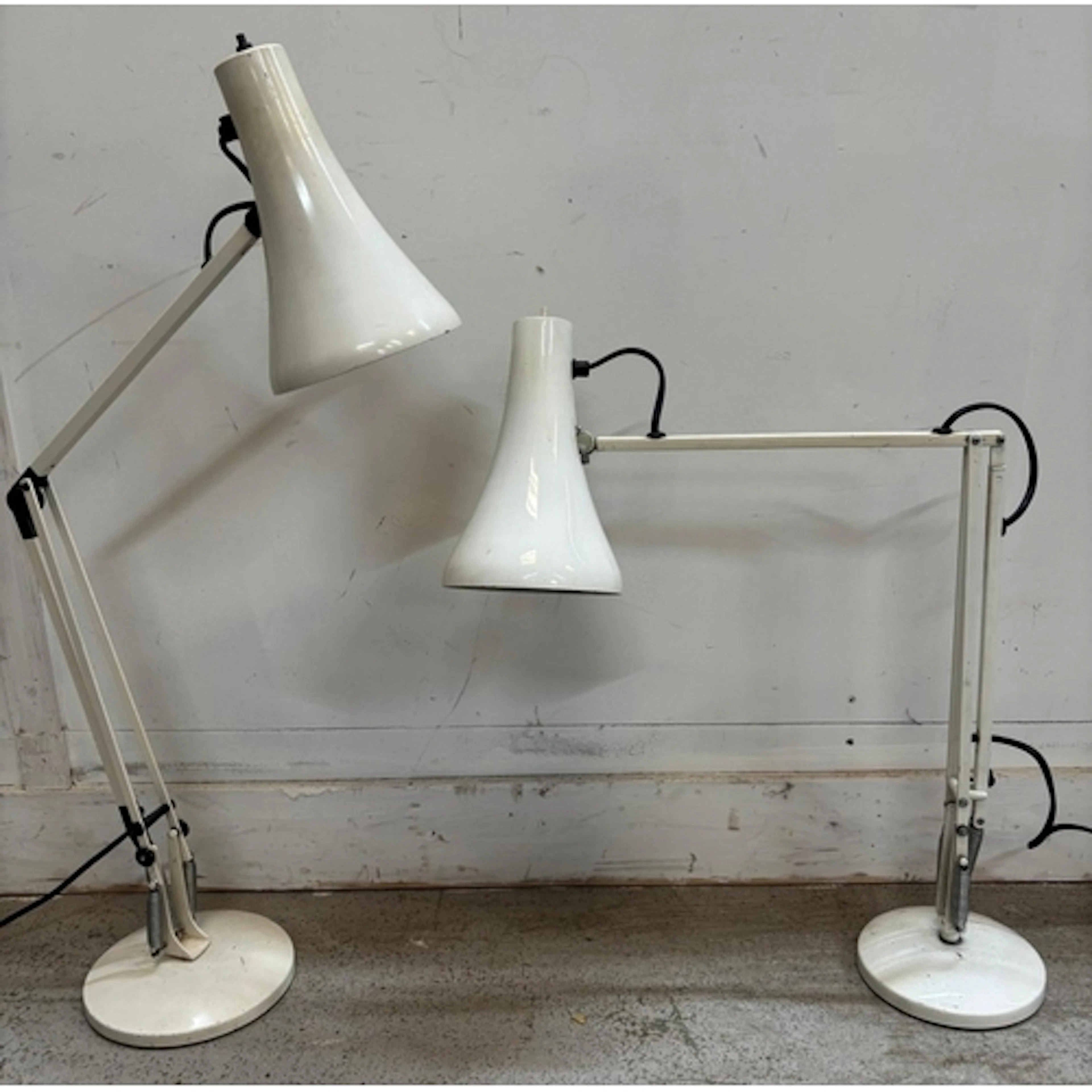 Two vintage white Anglepoise desk lamps featuring adjustable...
