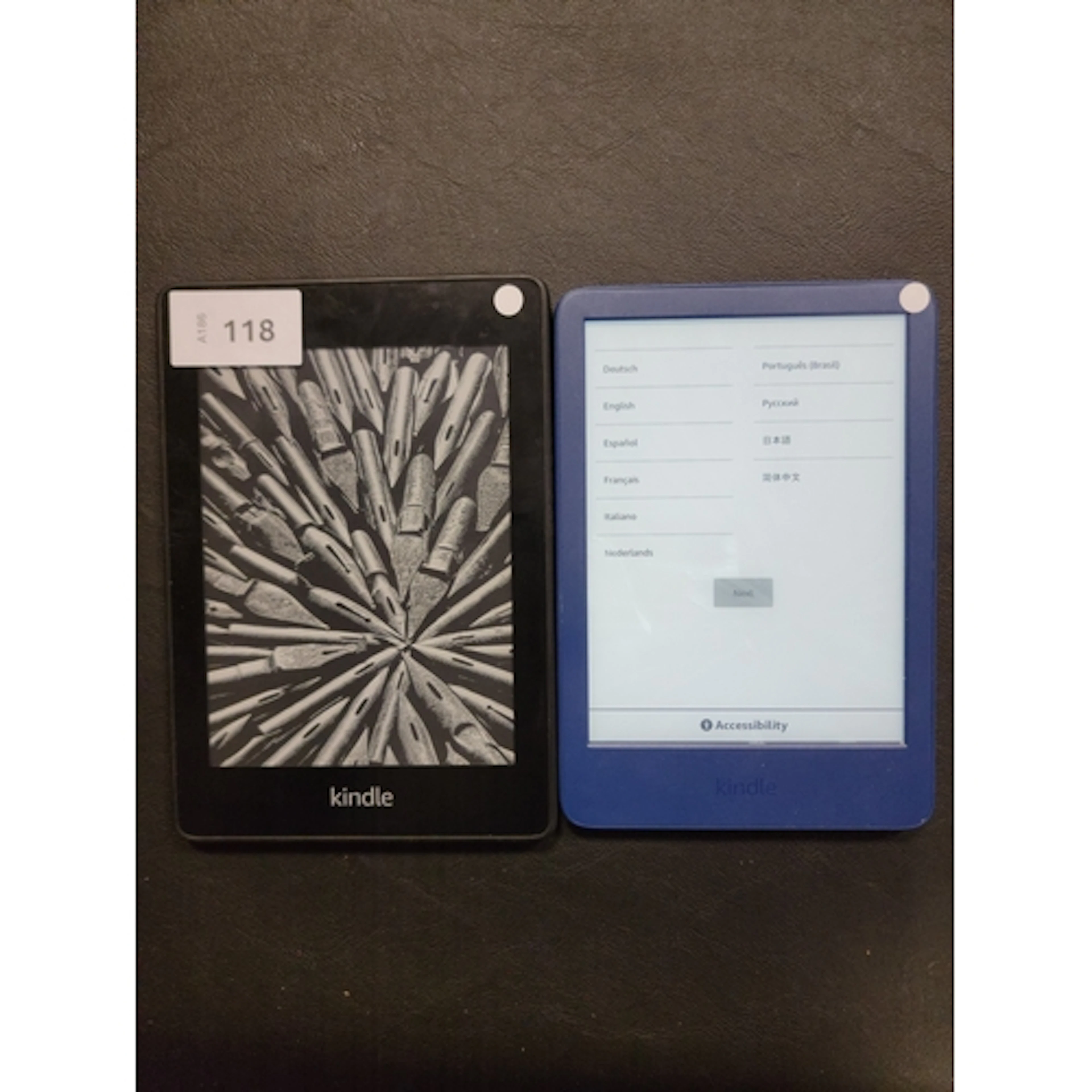 TWO AMAZON KINDLE E-READERS comprising a Paperwhite 4, seria...