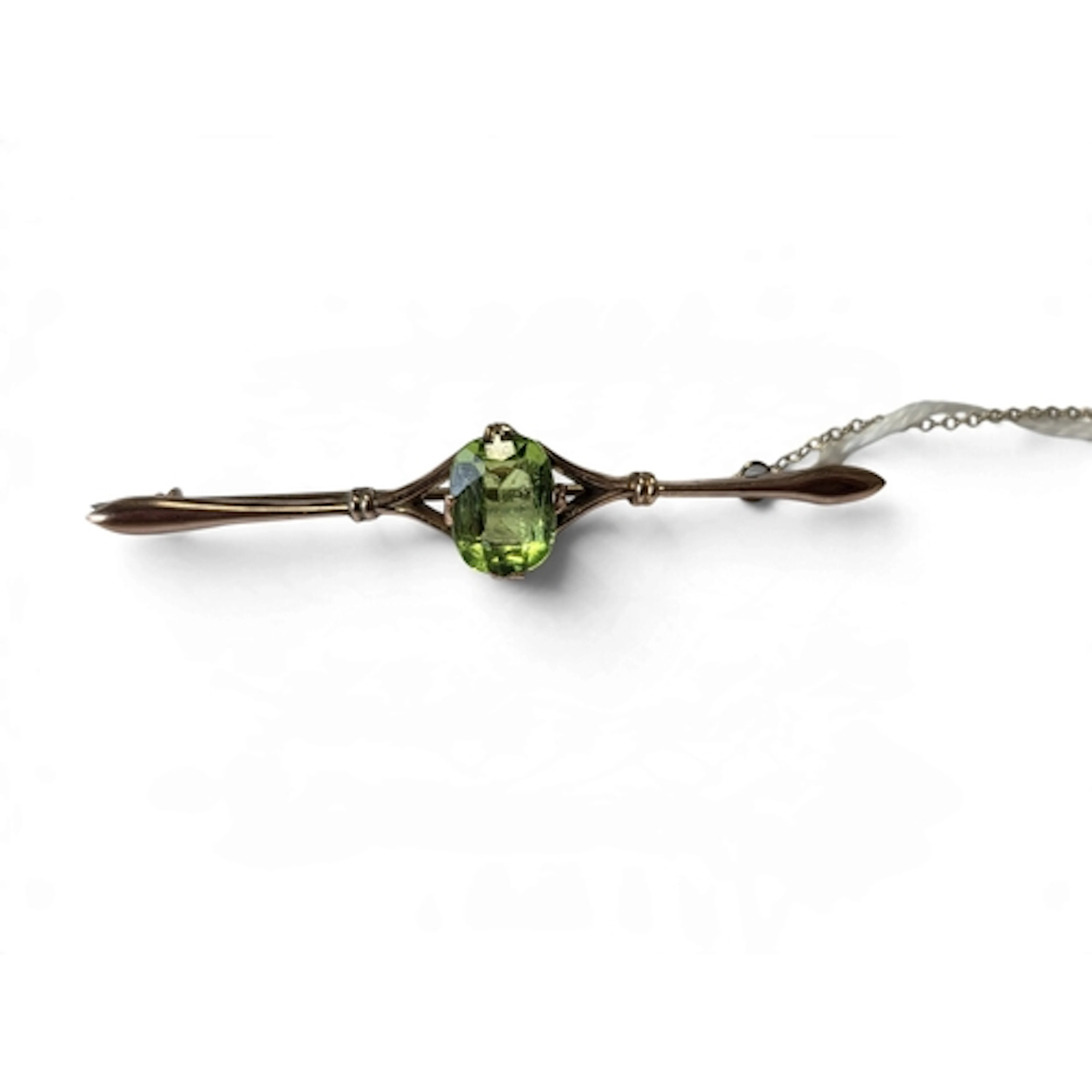 An Edwardian 9-carat gold peridot brooch, set with a natural...
