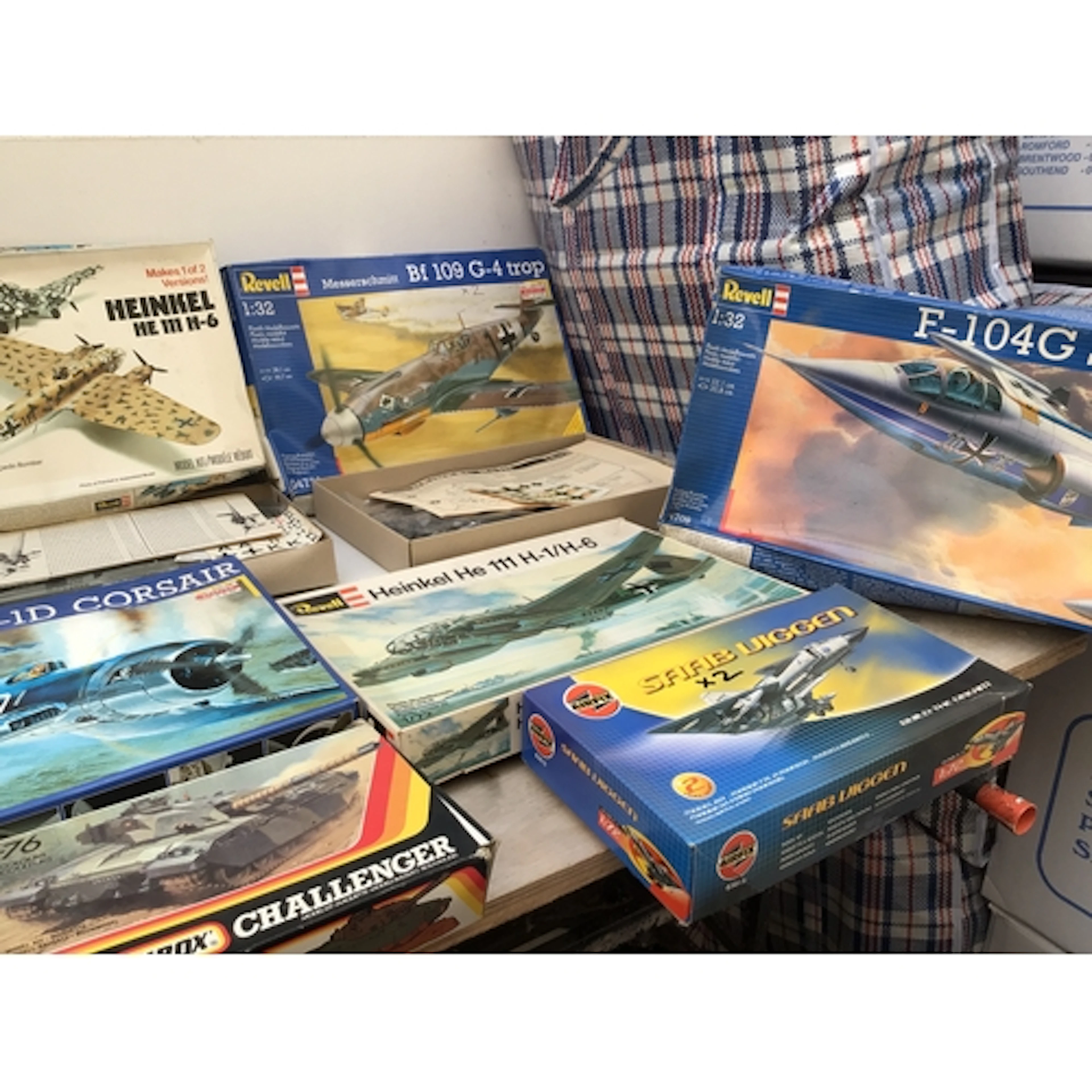 A bag containing a collection of boxed model kits comprising...