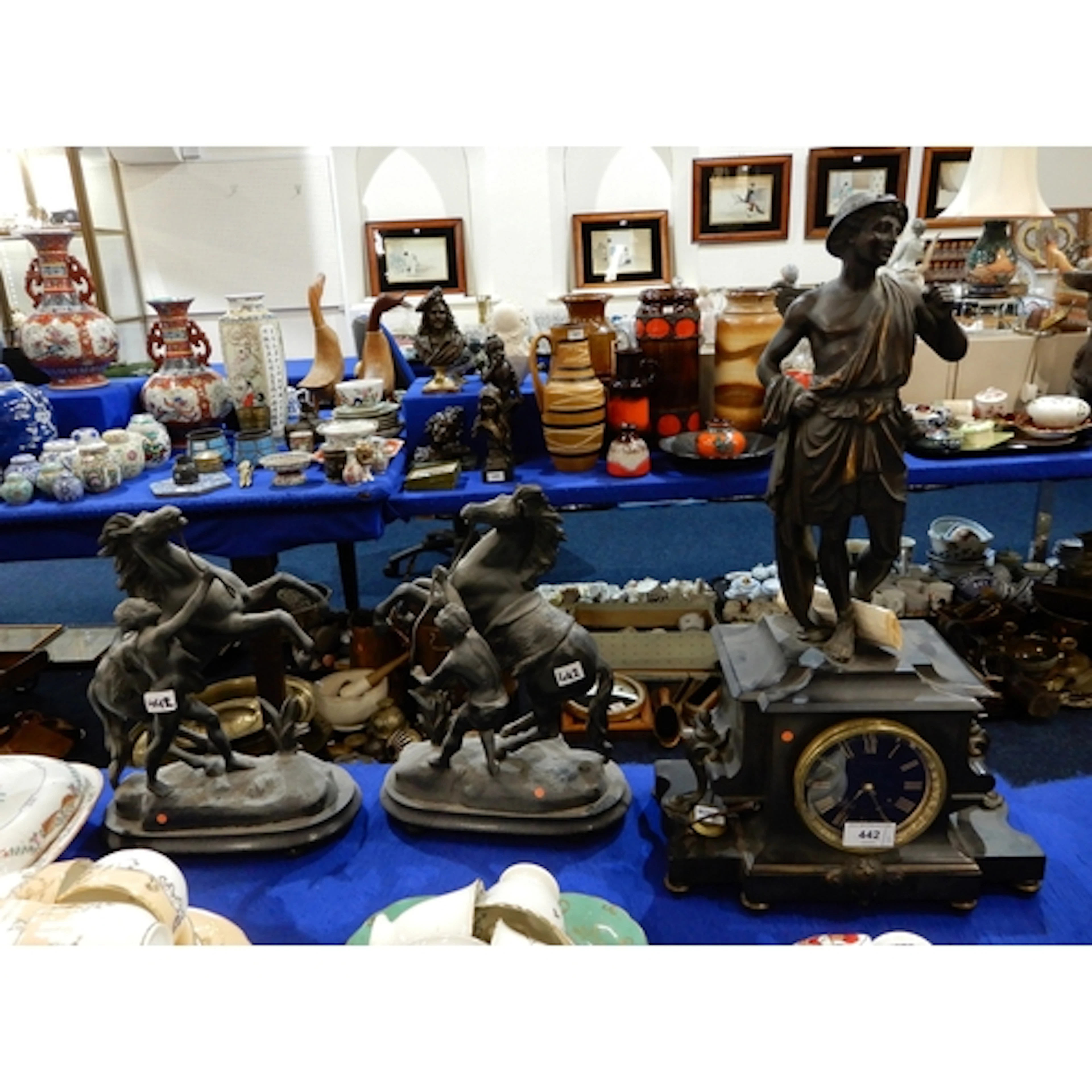 A slate mantle clock with spelter figure to top and a pair o...