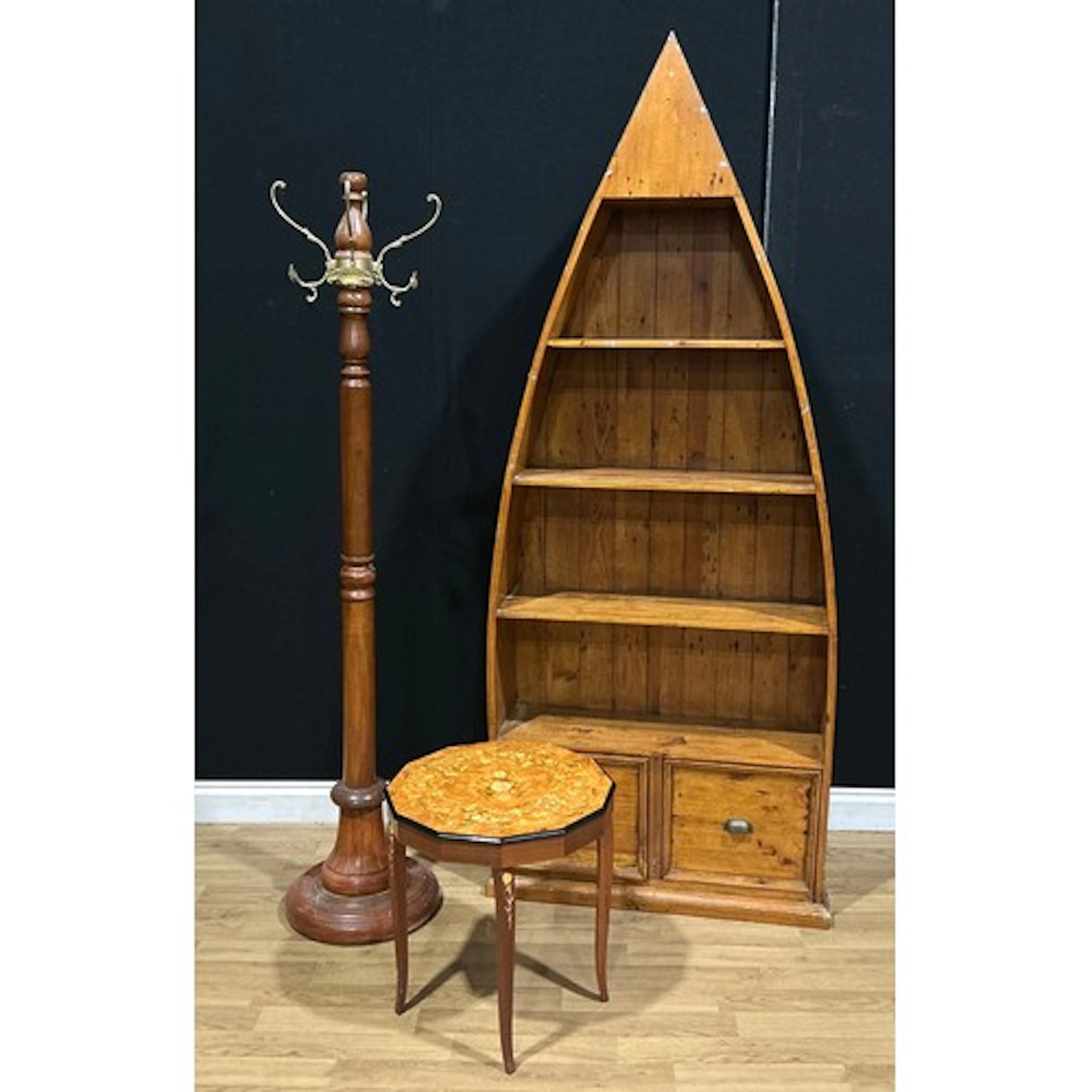 A contemporary boat-form open bookcase, 205cm high, 84cm wid...