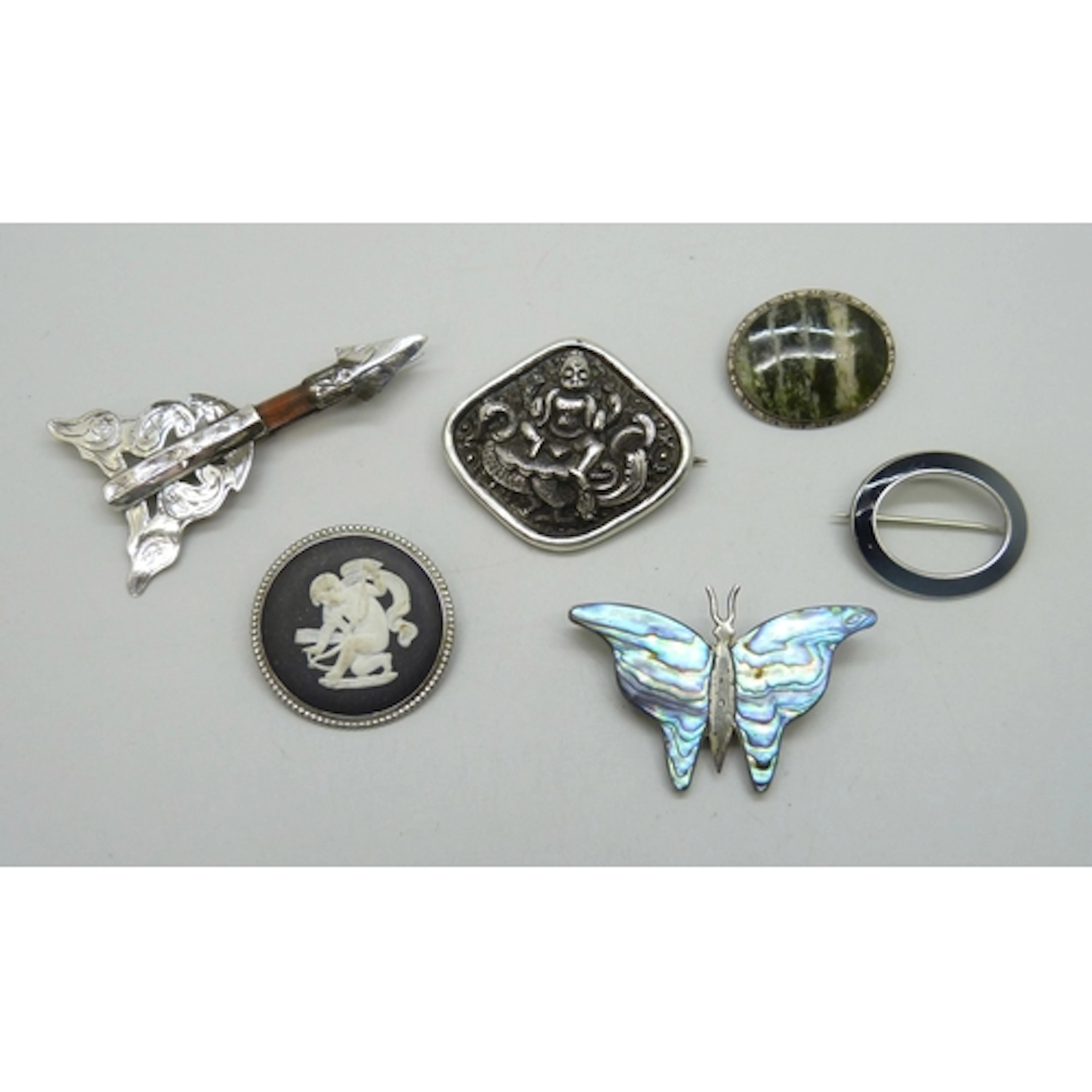 Three silver brooches including a Wedgwood Jasperware exampl...