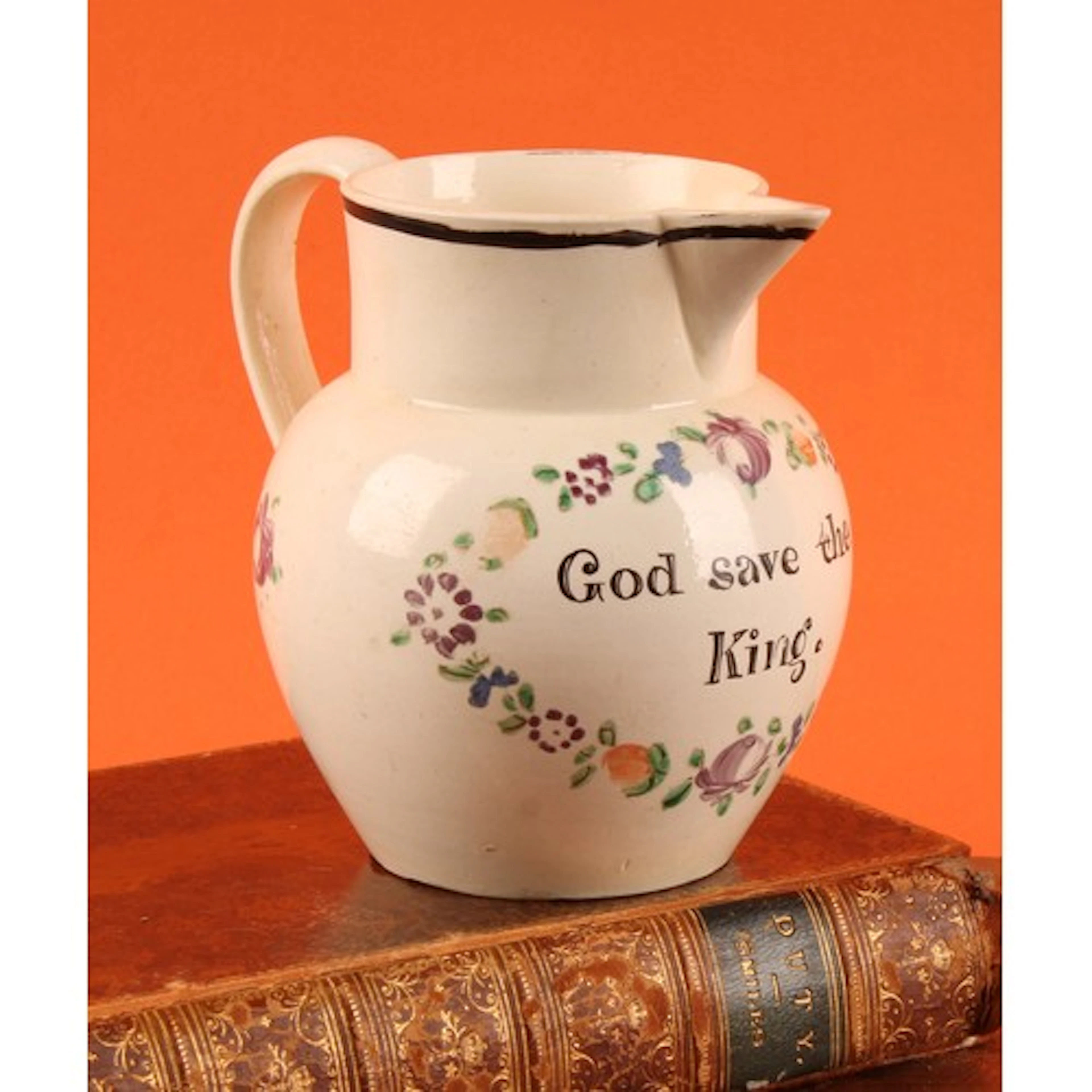A 19th century creamware jug, inscribed God save the King, w...