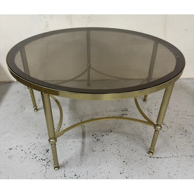 A smoked glass topped brass circular coffee table