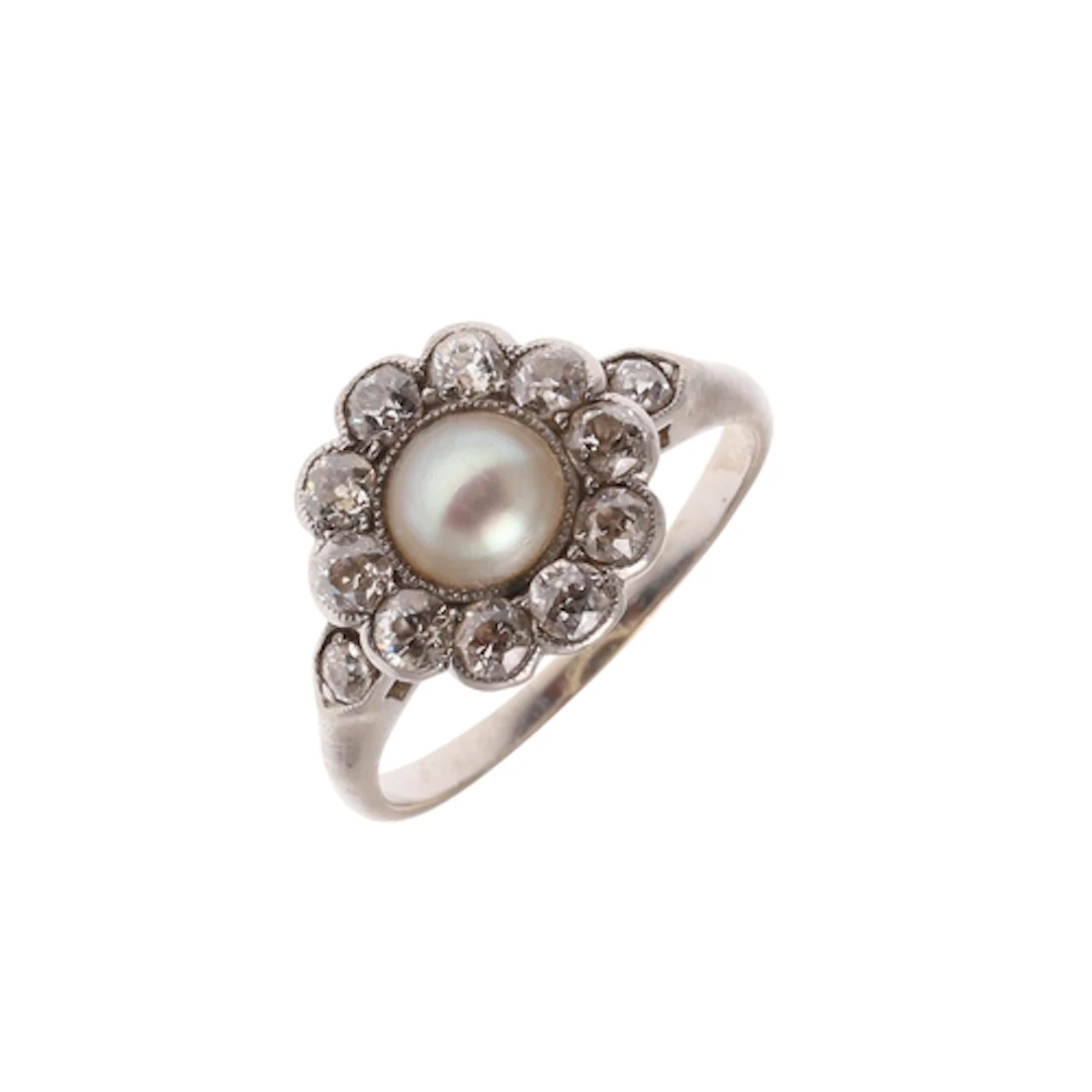 A DIAMOND AND PEARL CLUSTER RING. the central untested half ...