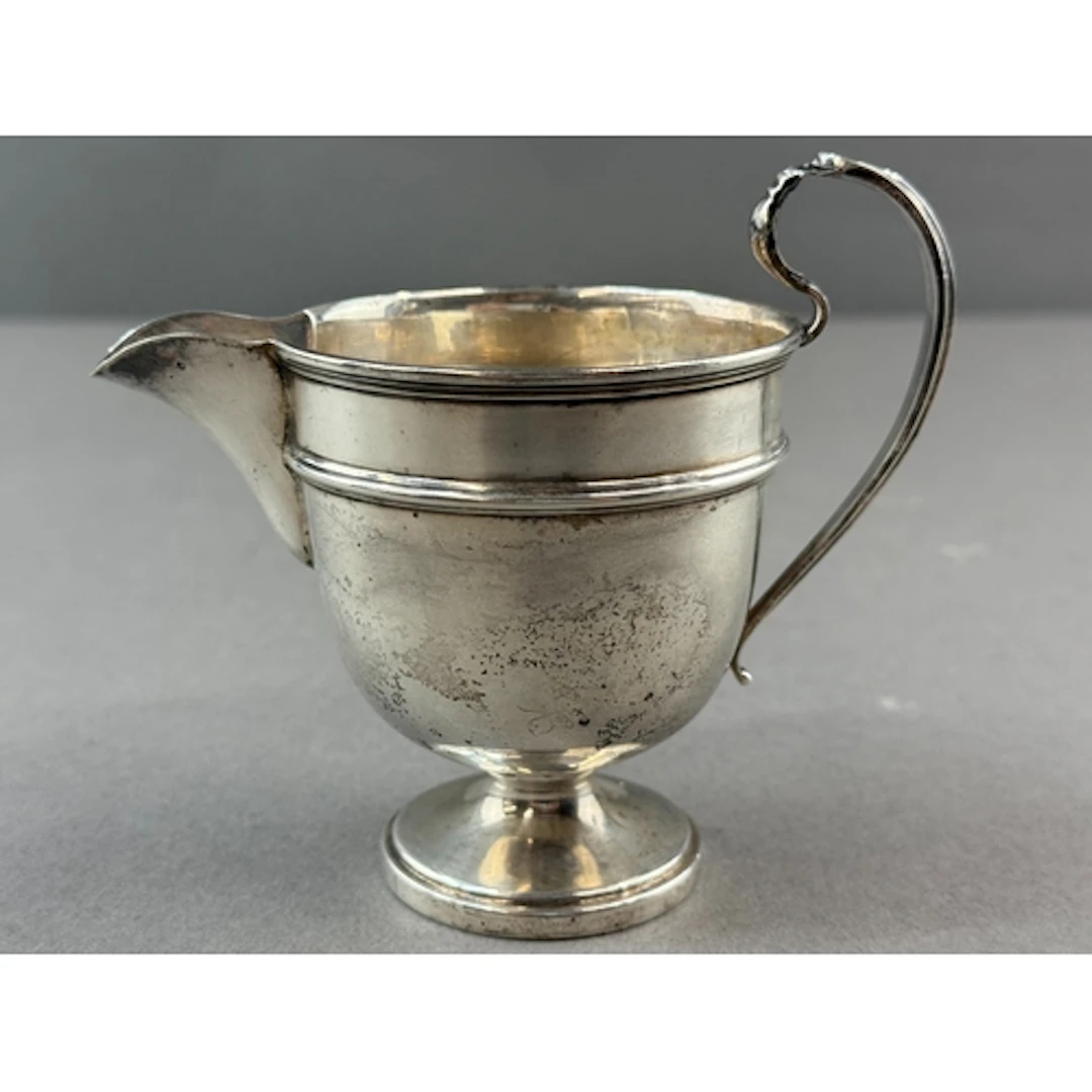 Silver: a George V cream jug by Emile Viner, Sheffield 1934,...