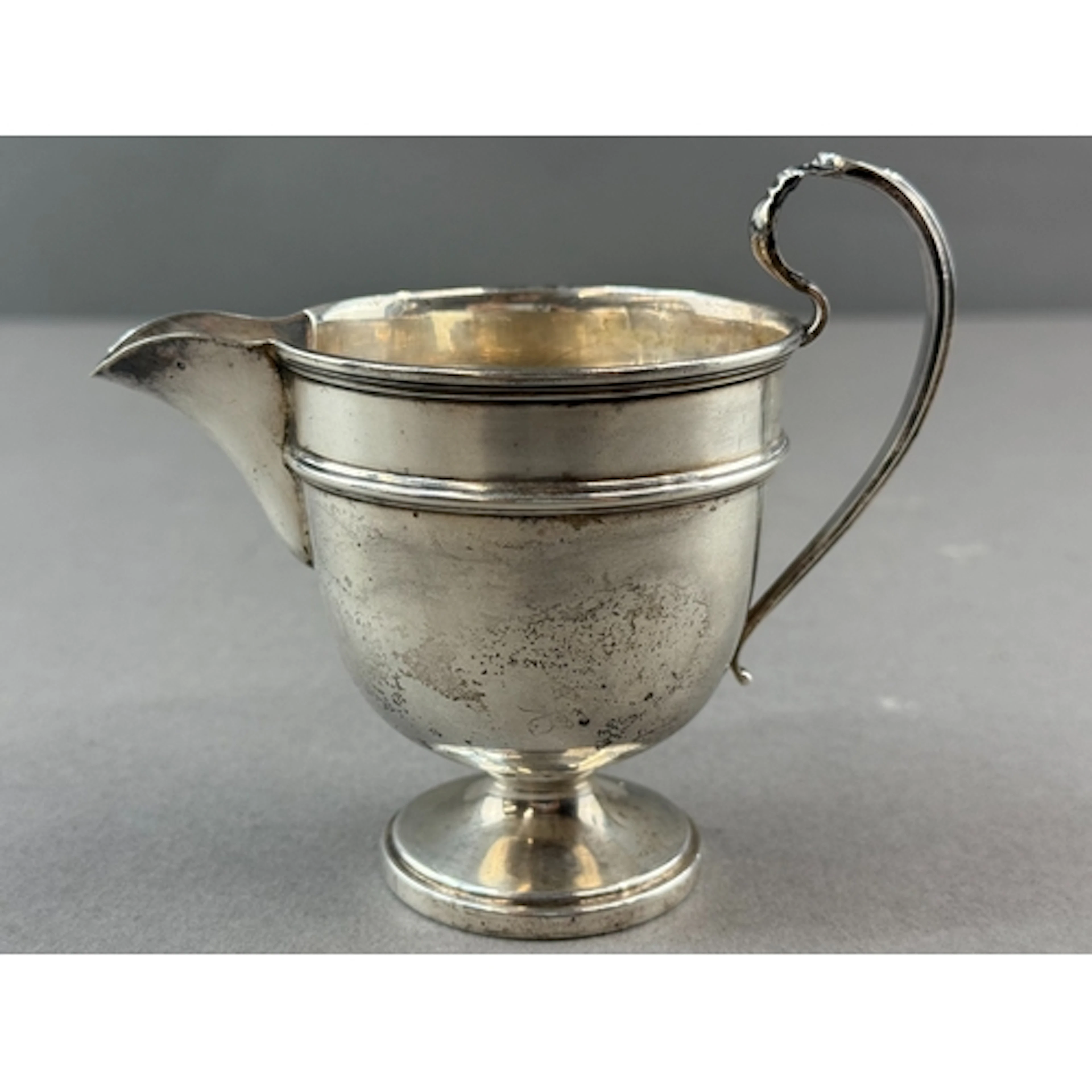 Silver: a George V cream jug by Emile Viner, Sheffield 1934,...