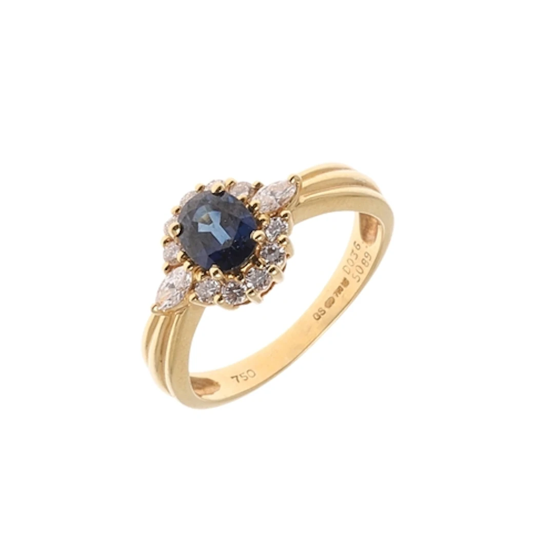 A SAPPHIRE AND DIAMOND CLUSTER RING. the oval-shaped sapphir...