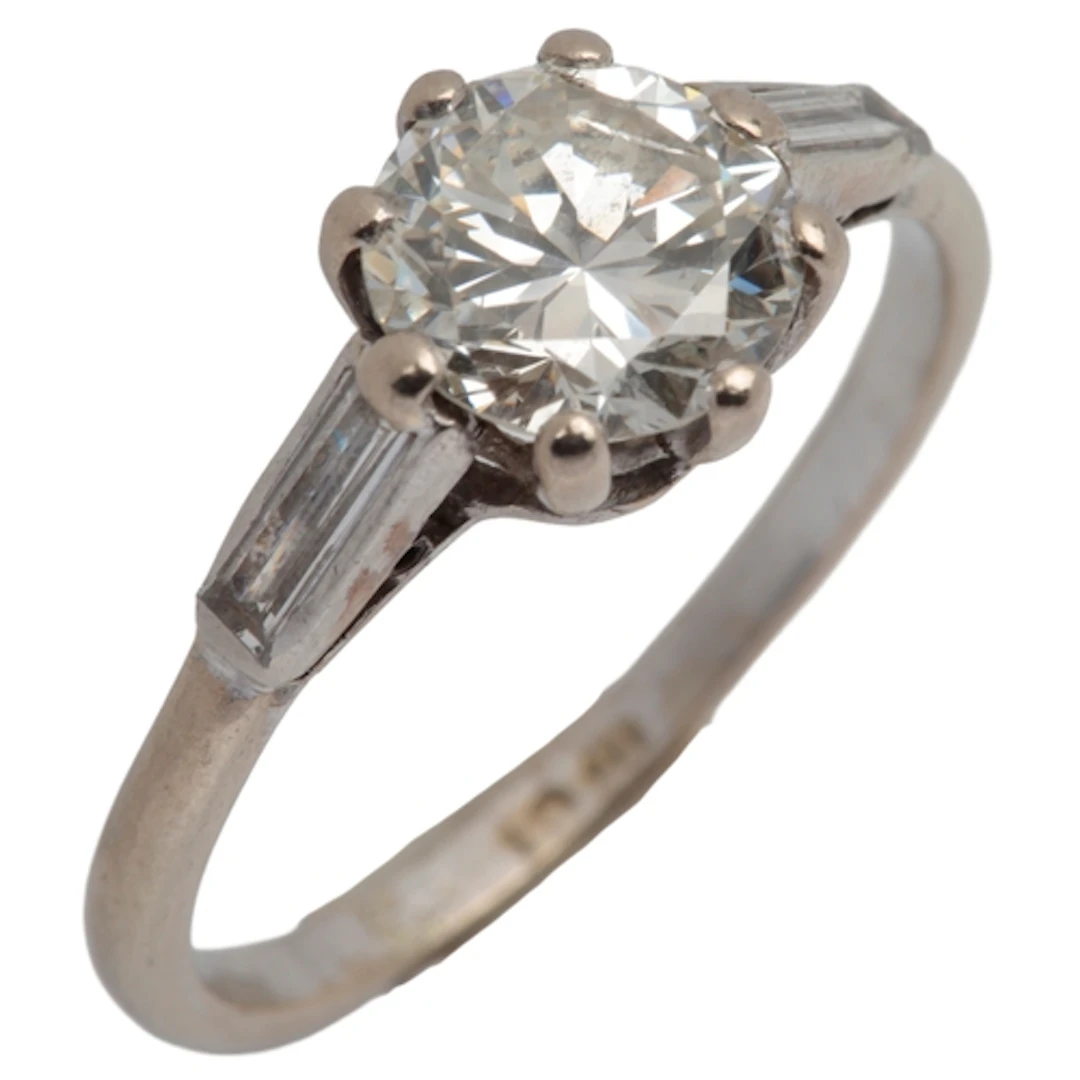 A diamond ring, claw-set with a brilliant-cut diamond measur...