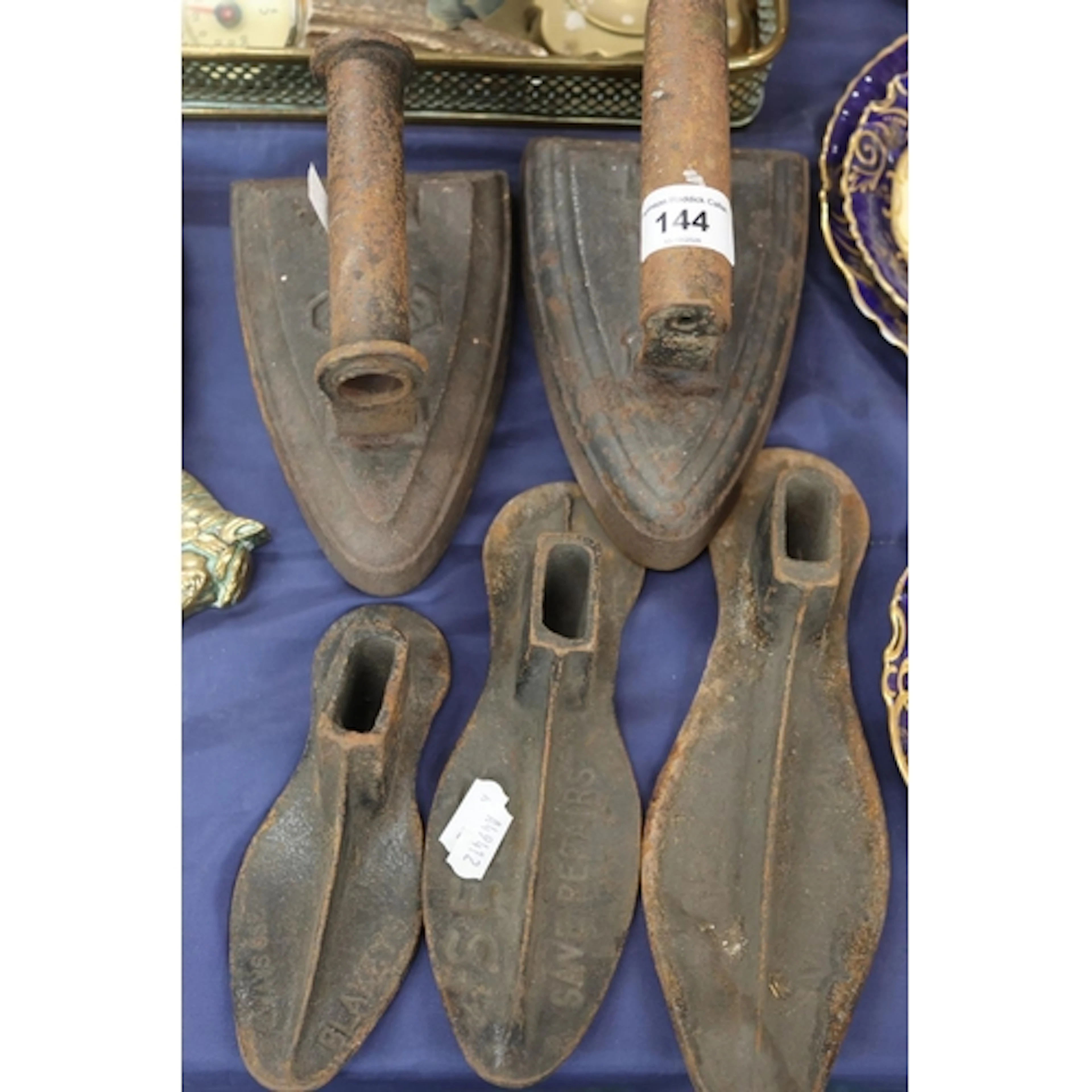 Pair of cast irons and three shoe lasts.