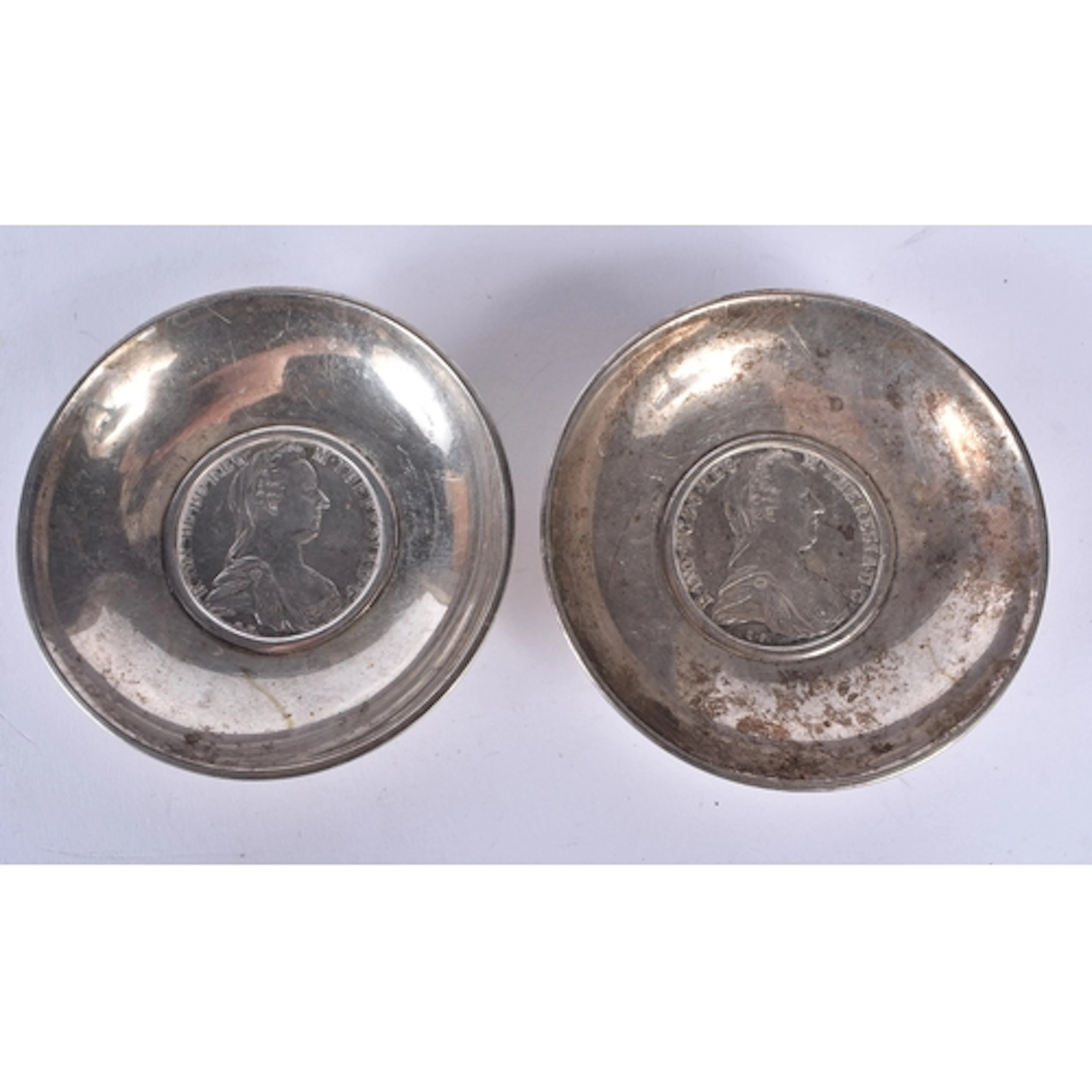A white metal coin dish with an Austrian coin insert depicti...