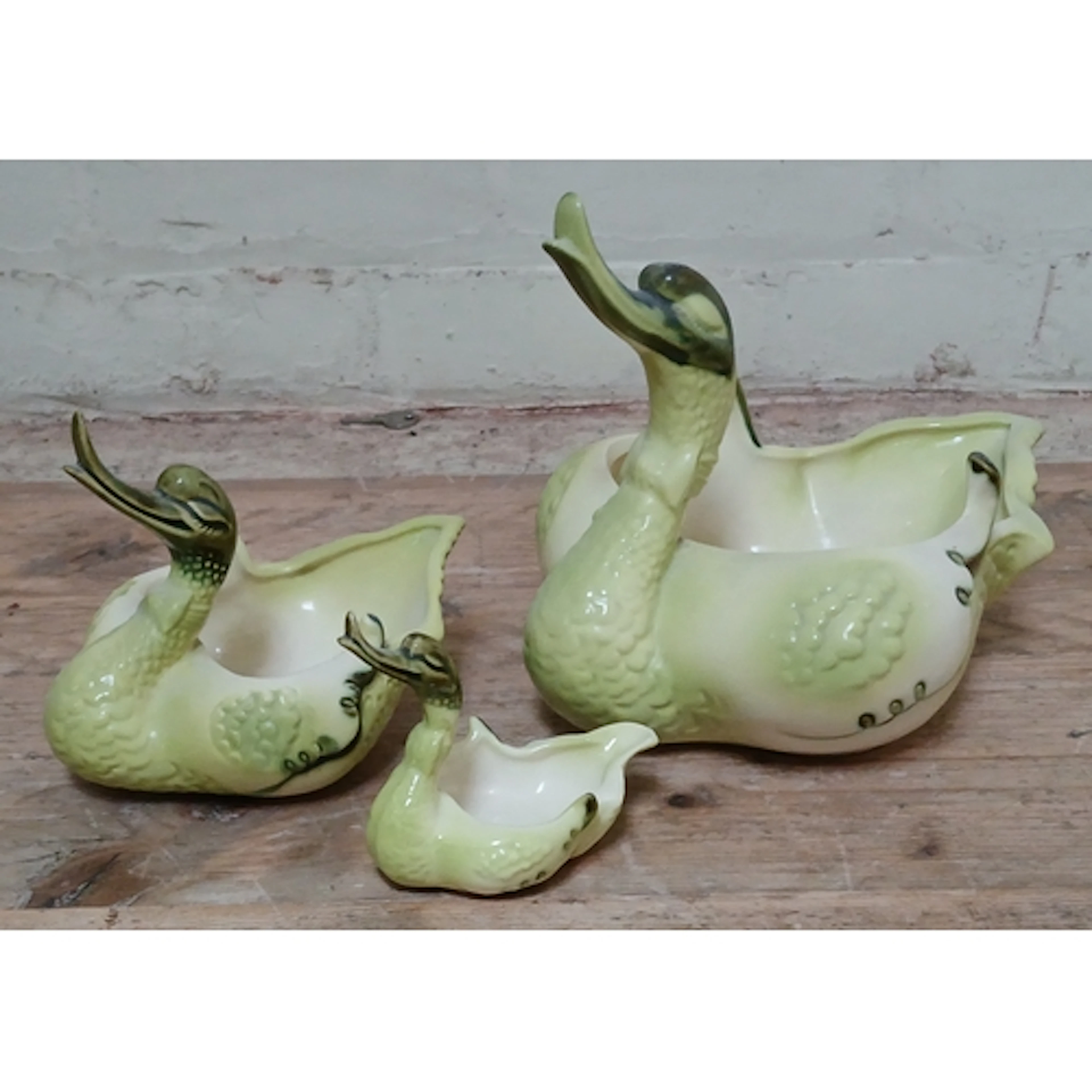 A set of three graduated pottery dishes modelled as swans by...