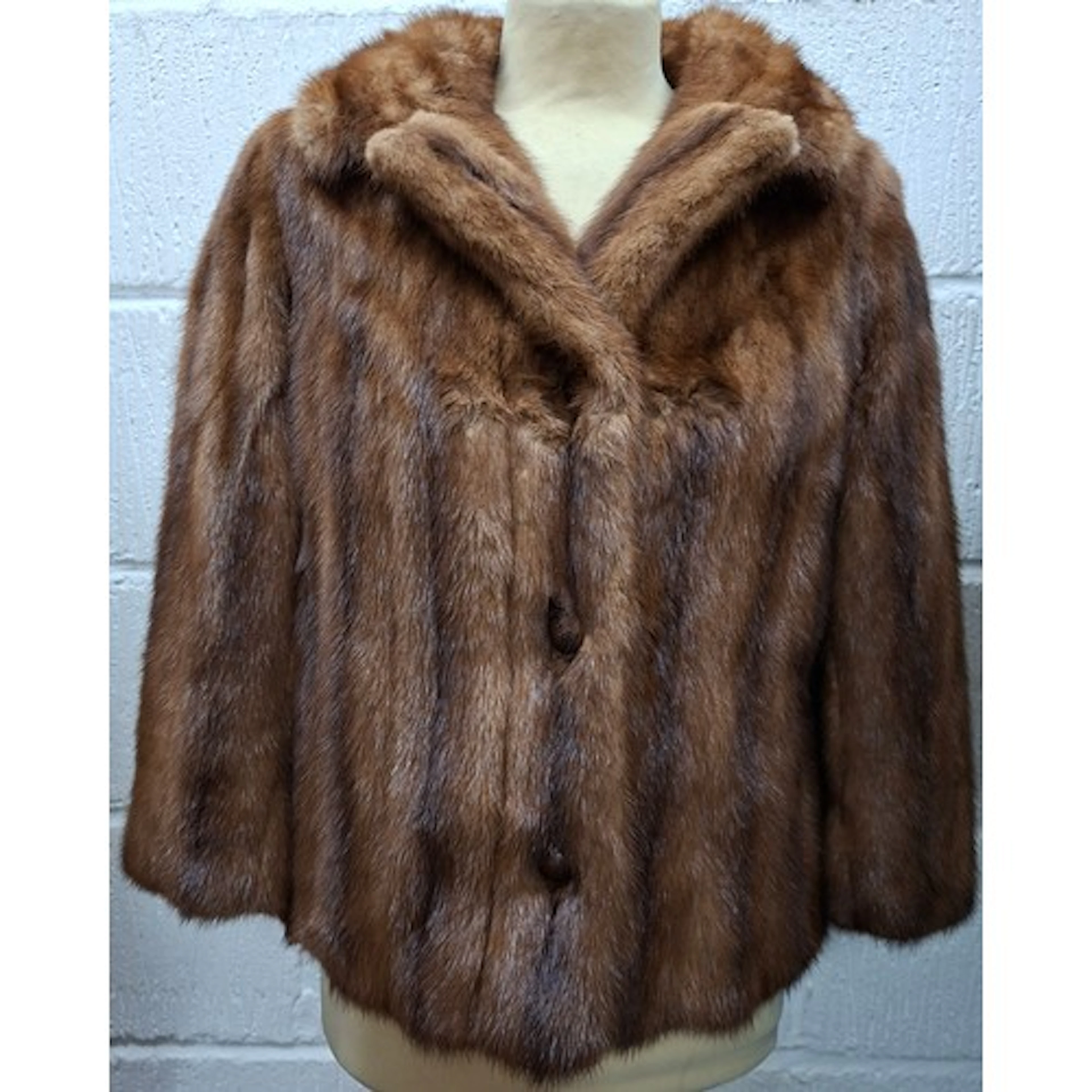 A 1960's mid brown mink opera jacket having ¾ sleeves and a ...