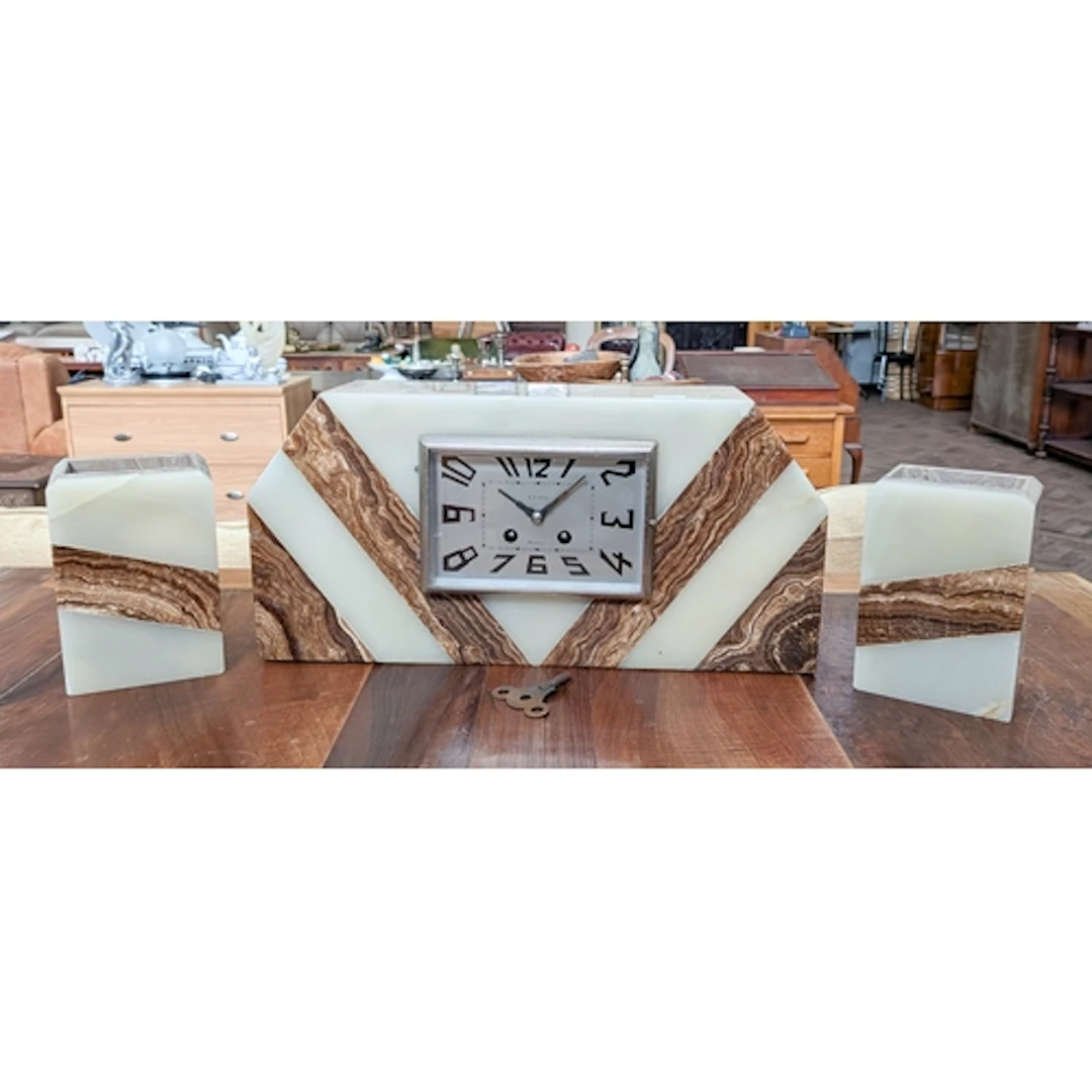 French Art Deco three piece marble and onyx mounted clock ga...