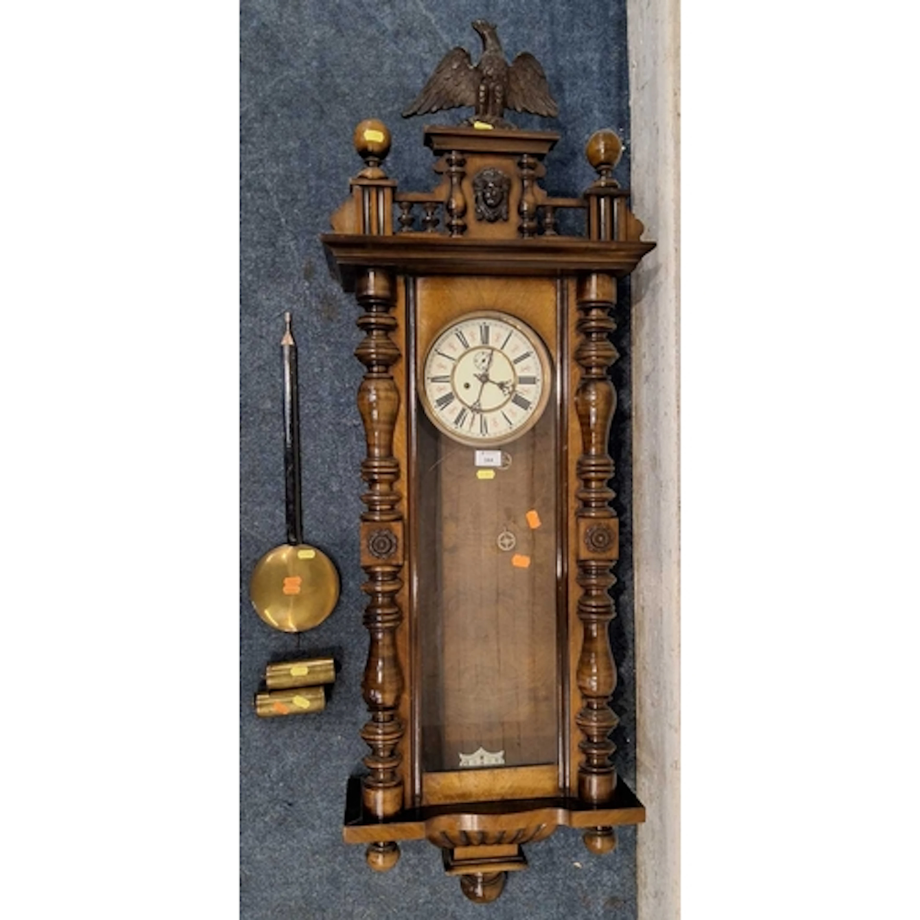 A 20TH CENTURY WALNUT WALL CLOCK, with an eagle pediment, ov...