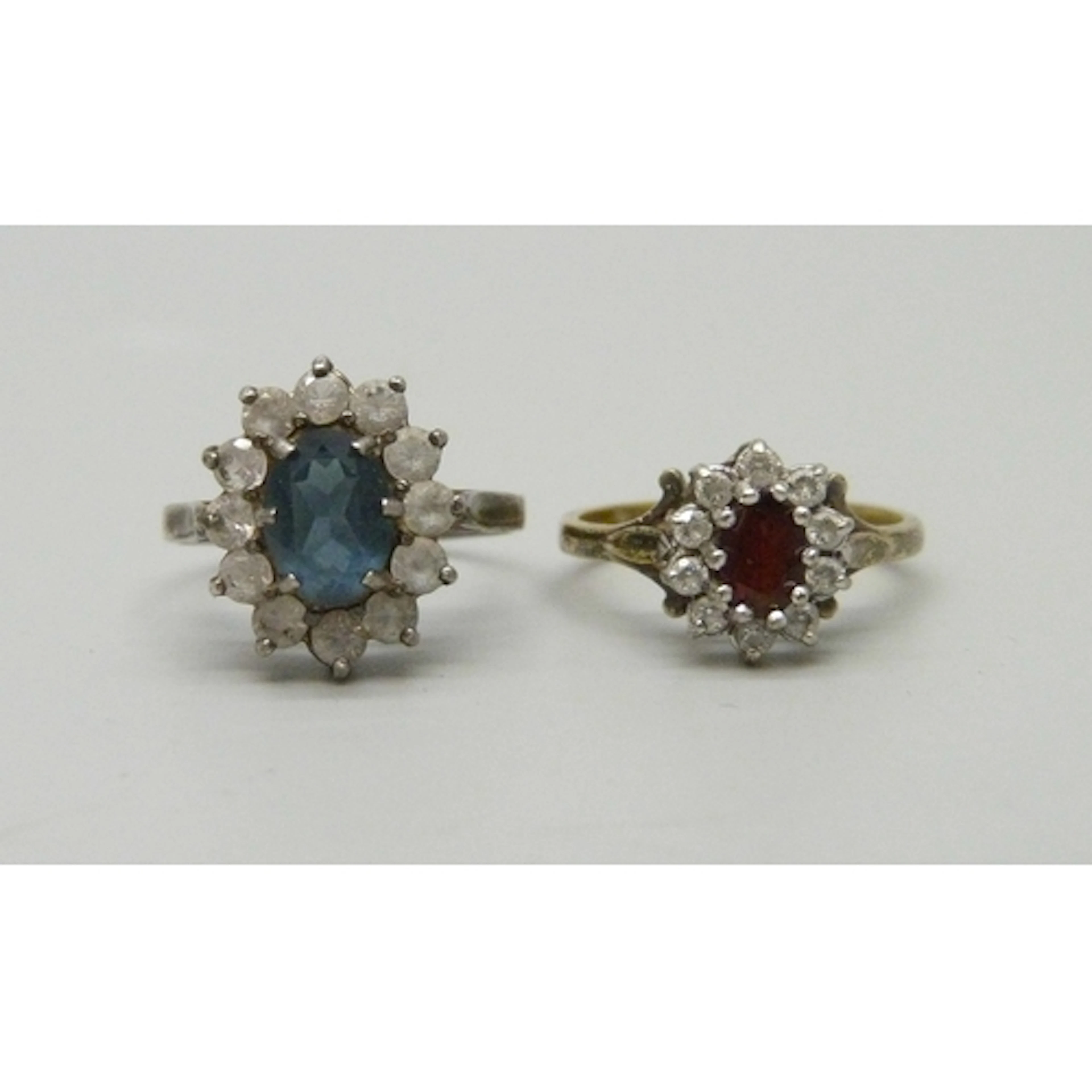 Two silver cluster rings including a gilt example, silver ex...
