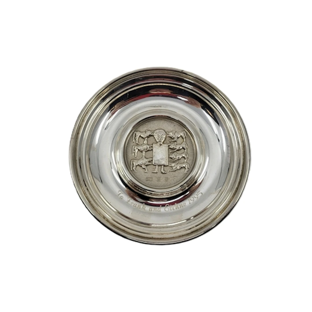 A MODERN IRISH STERLING SILVER DISH, decorated from the high...