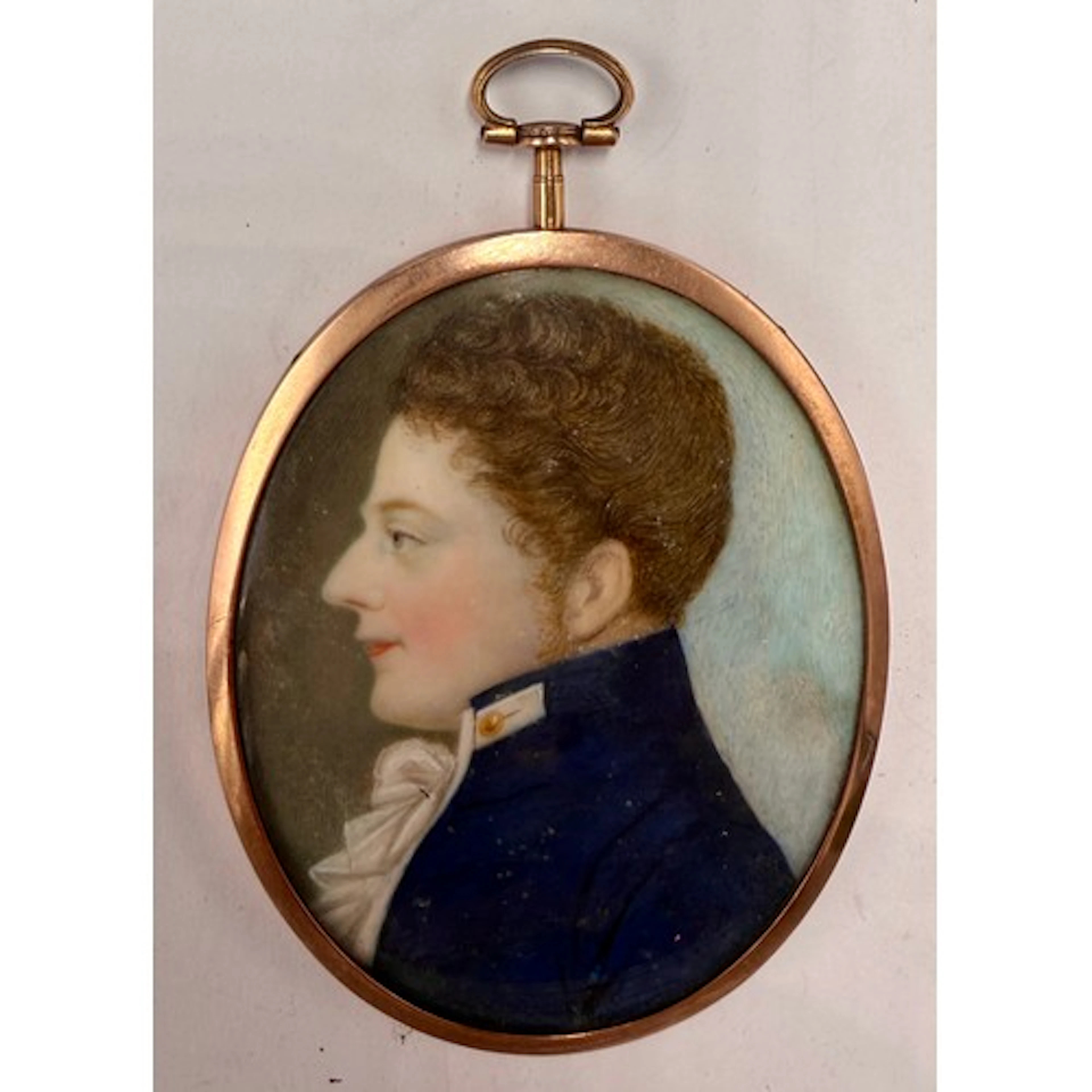 A miniature painting on ivory depicting a gentleman in blue ...