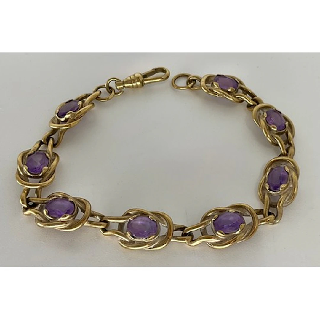A 9ct gold amethyst accented bracelet, with eight knot links...