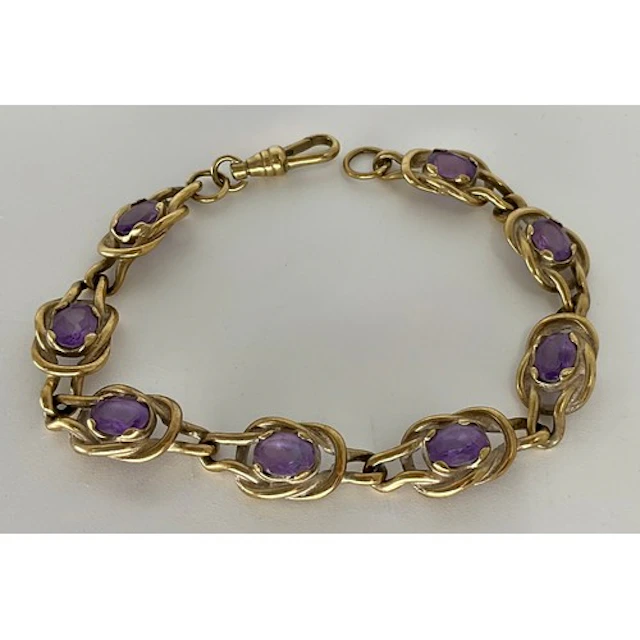 A 9ct gold amethyst accented bracelet, with eight knot links...