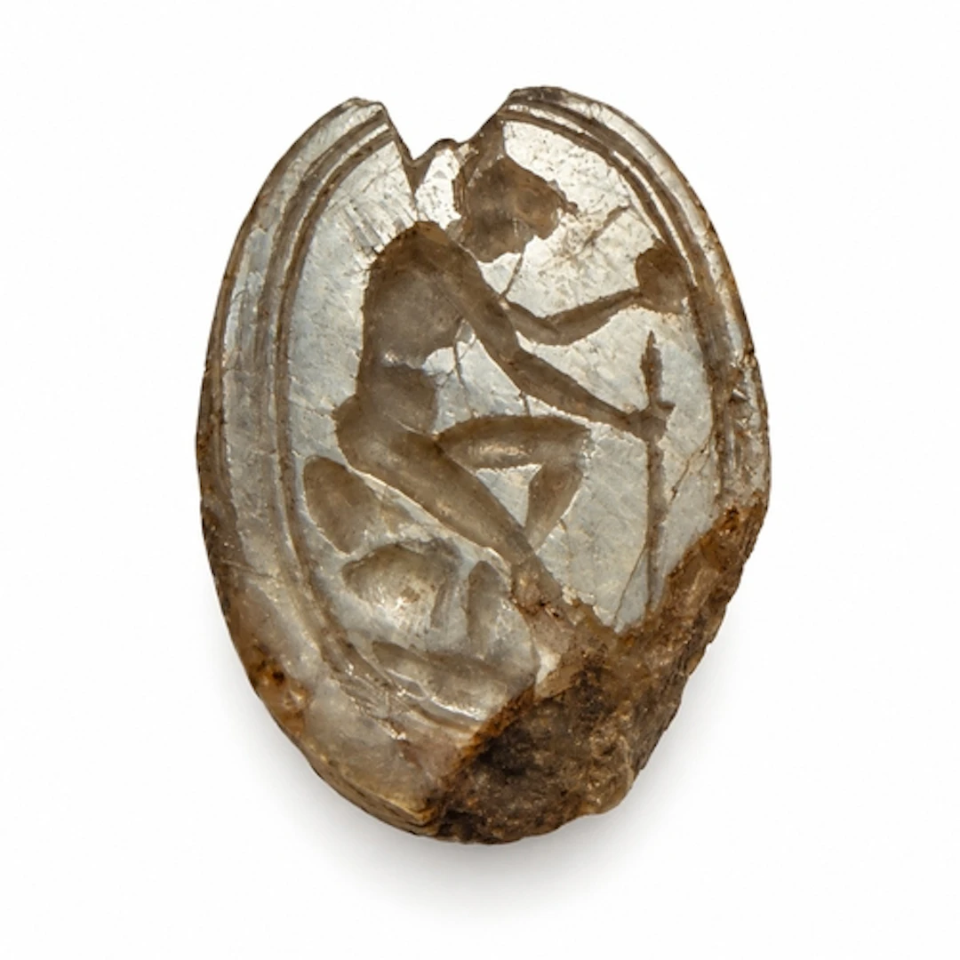 A carved labradorite scarab, the reverse engraved as an inta...