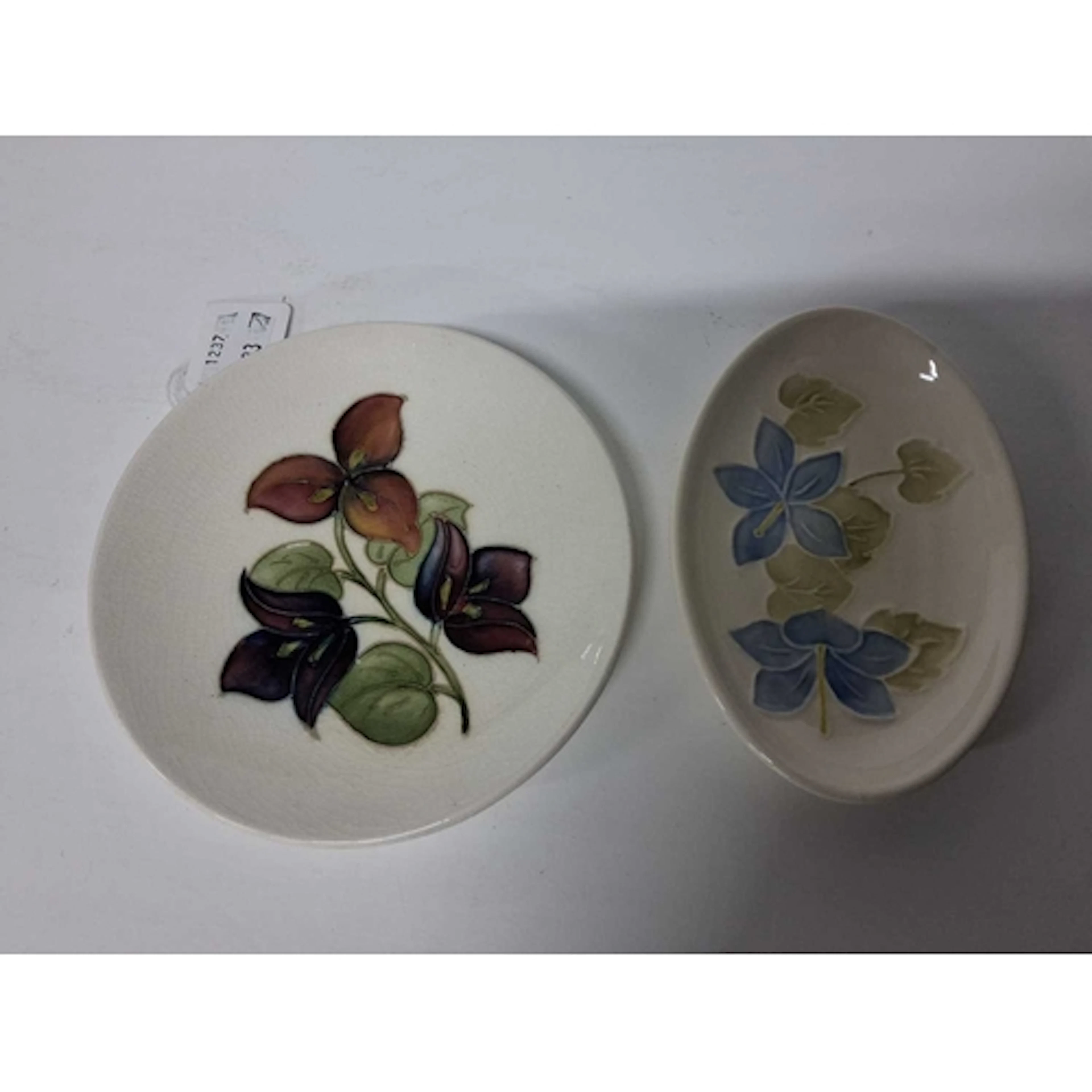 TWO MOORCROFT POTTERY TRINKET DISHES, comprising a Bougainvi...