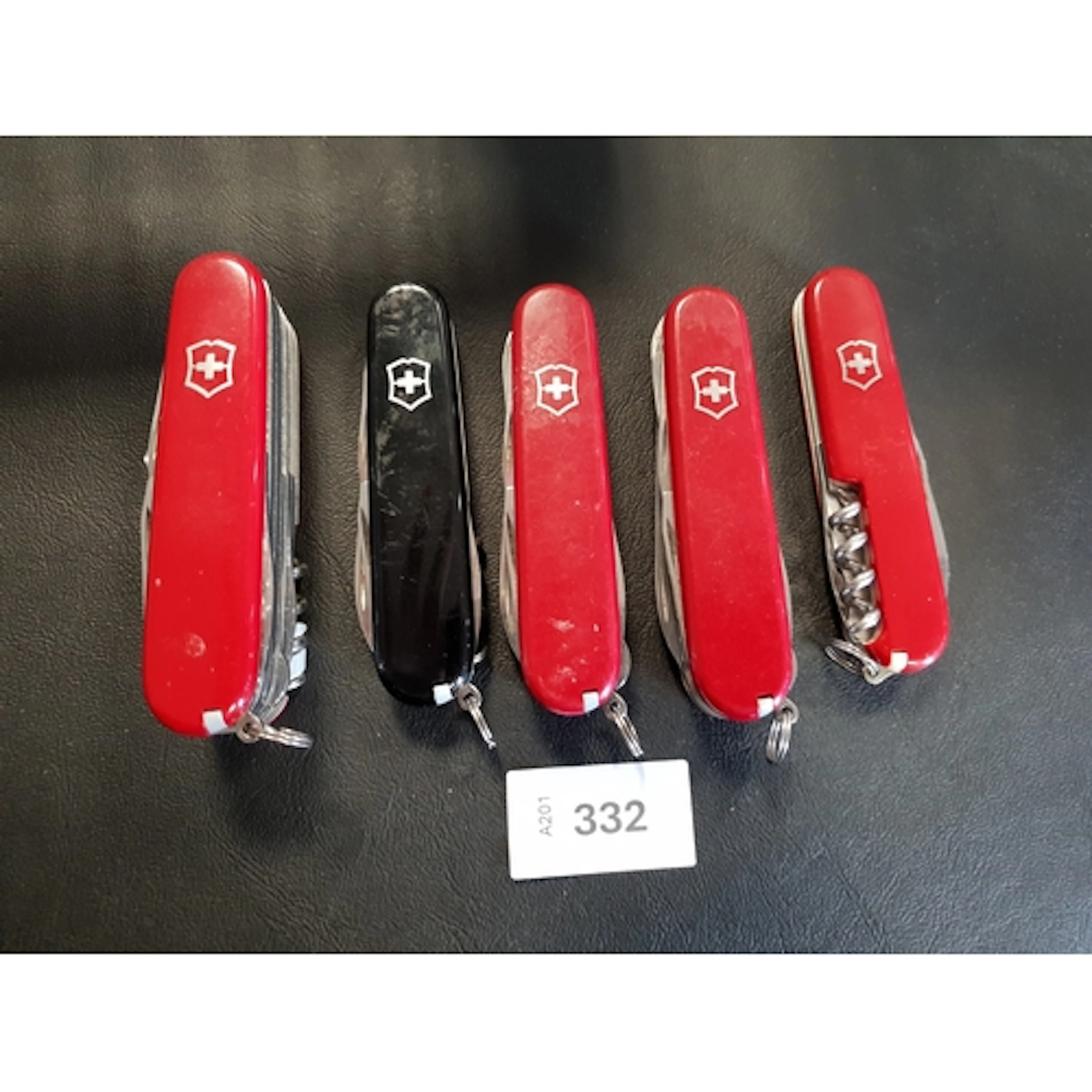 FIVE VICTORINOX SWISS ARMY KNIVES of various sizes and desig...