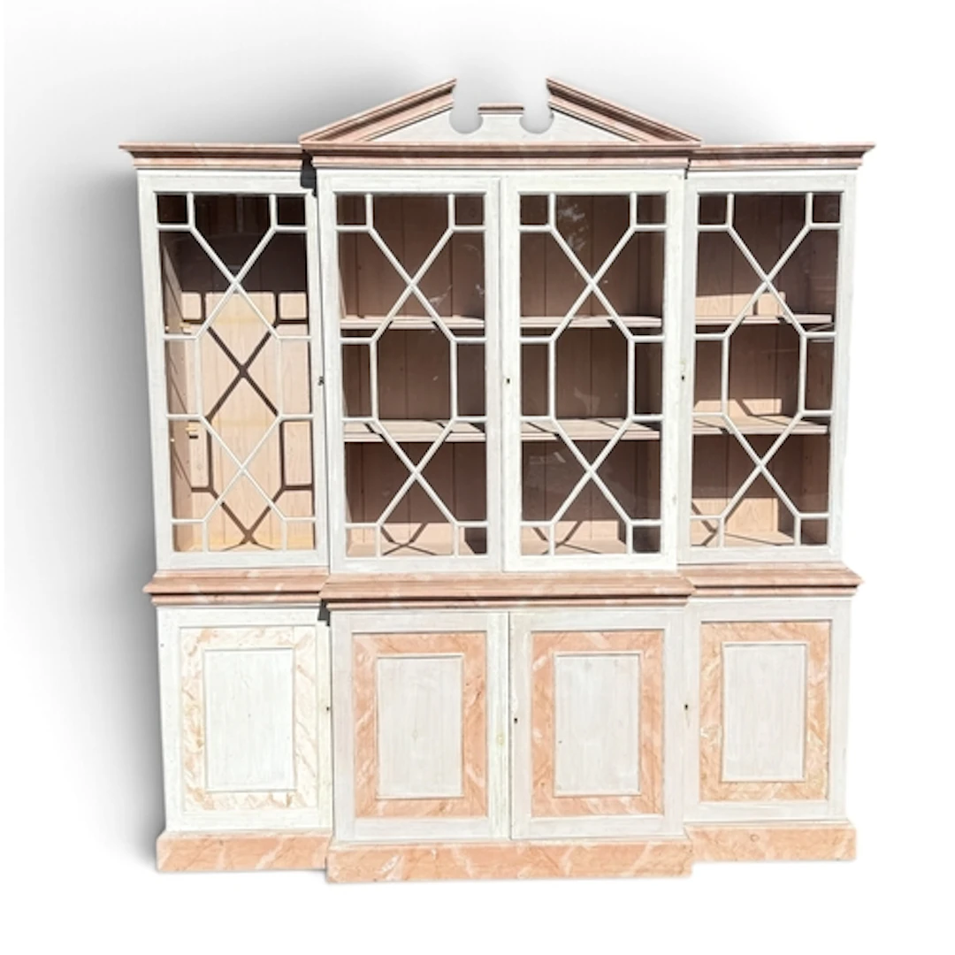 A GEORGE III STYLE PAINTED PINE BREAKFRONT BOOKCASE With cup...