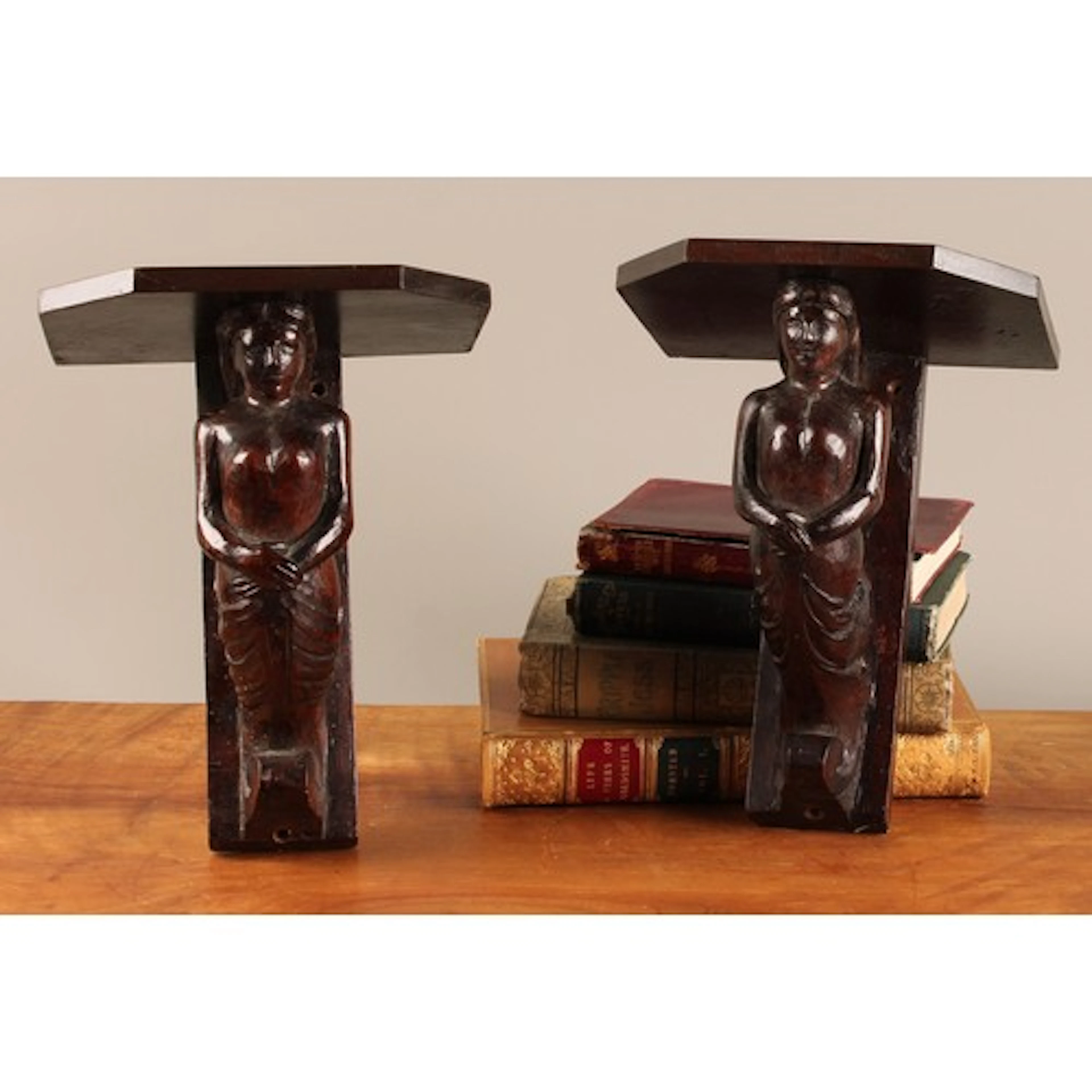 A pair of 19th century figural wall brackets, each carved wi...