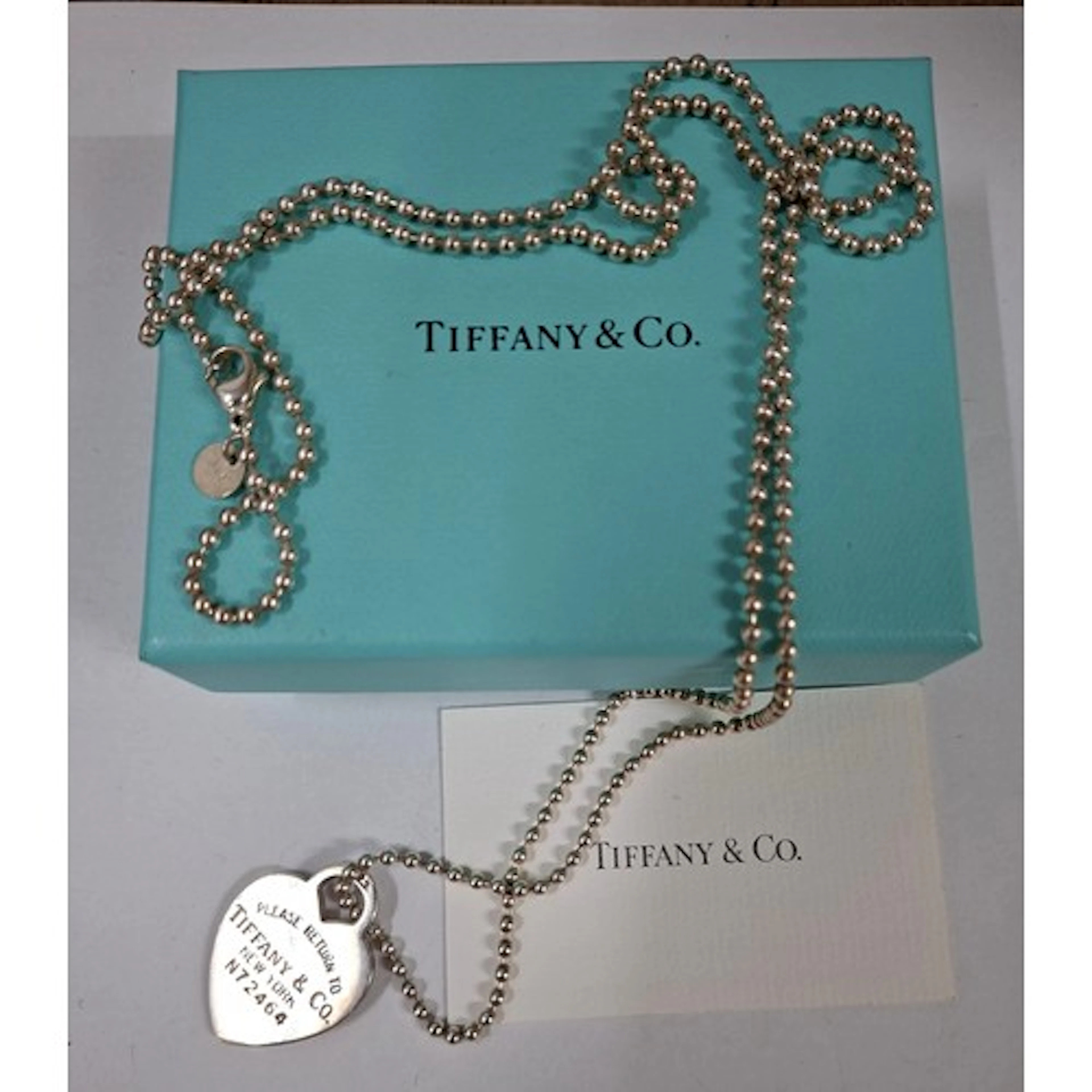 Tiffany & Co- A silver ball chain 90cm long having a 'Return...