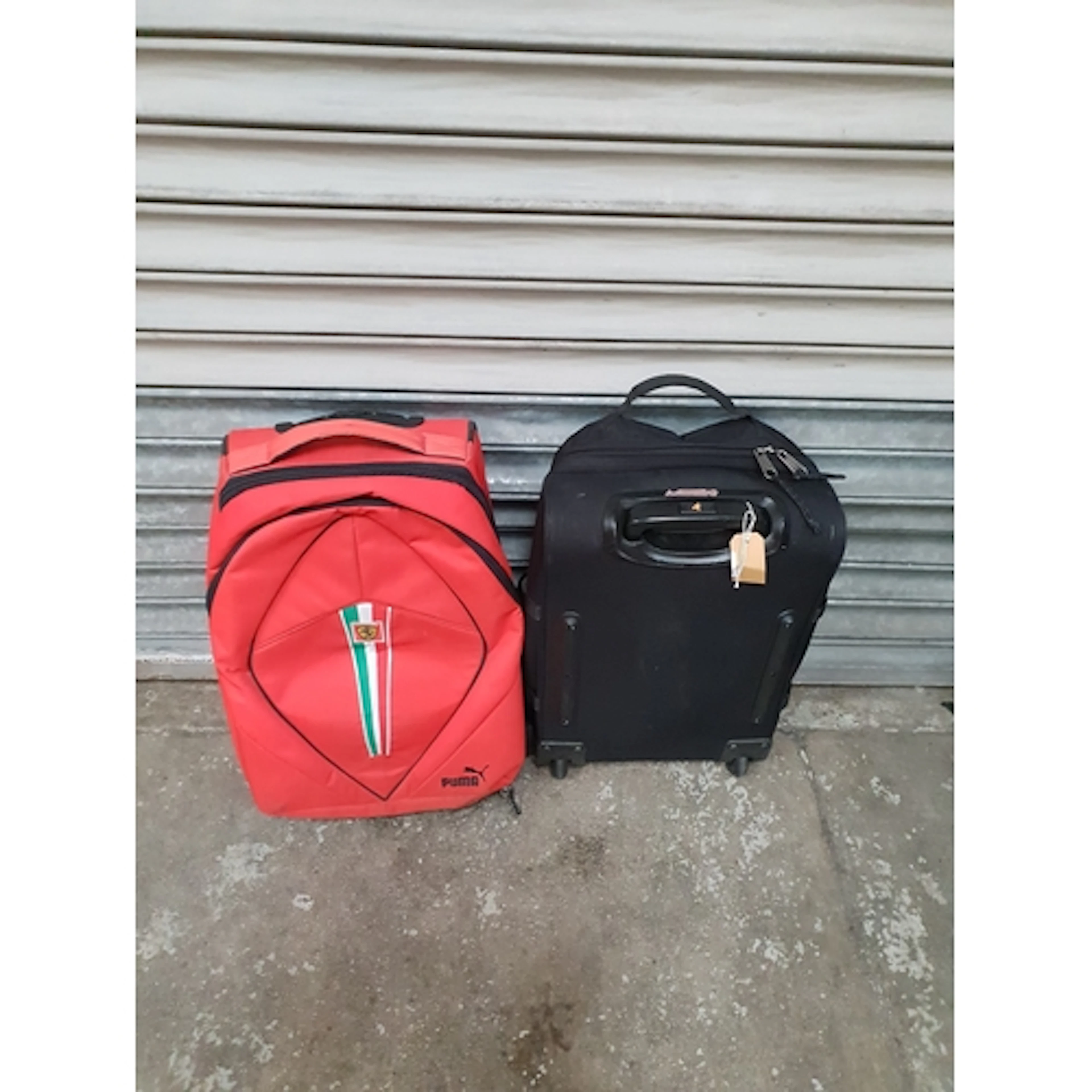 TWO TRAVEL BAGS COMPRISING EASTPACK AND PUMA FERRARI Note: a...