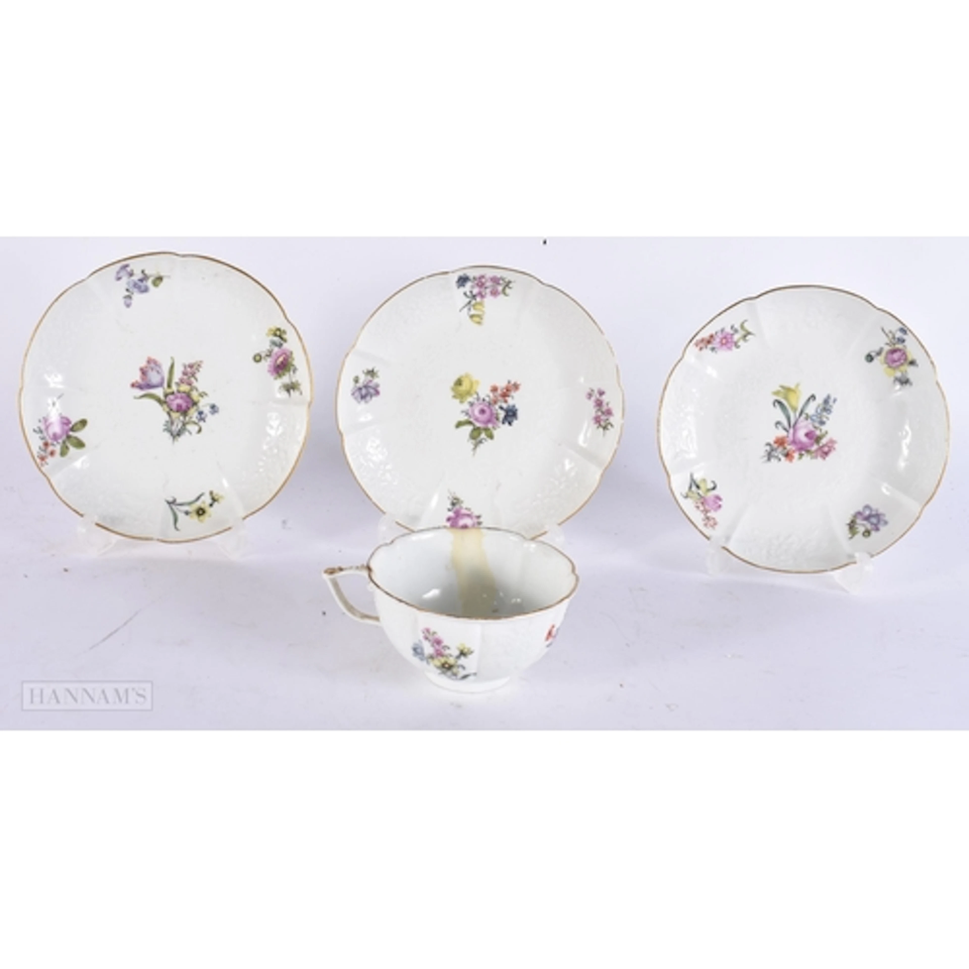 AN ANTIQUE MEISSEN PORCELAIN CUP AND SAUCER together with tw...