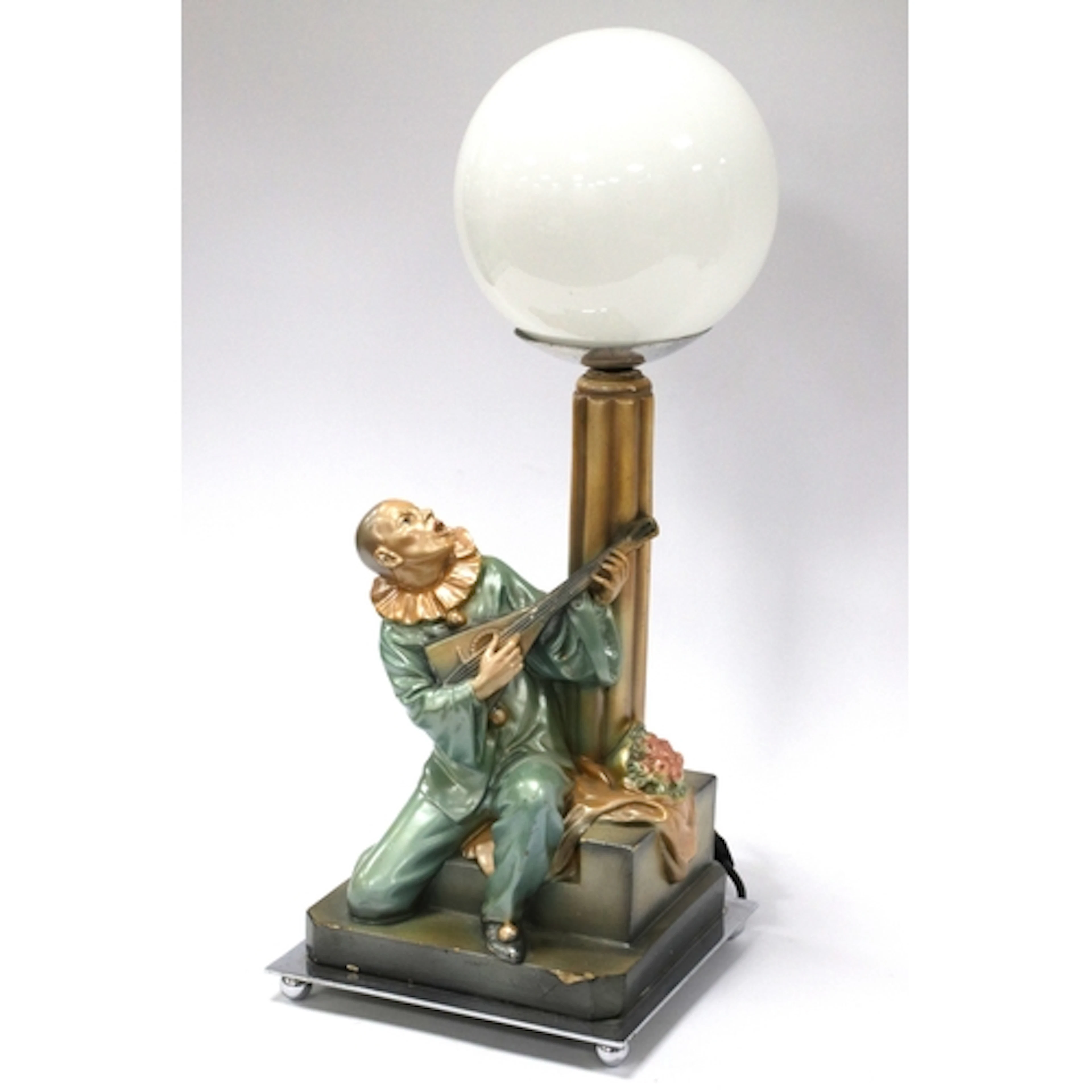 A 1930's Art Deco Table Lamp, modelled as a Pierrot playing ...